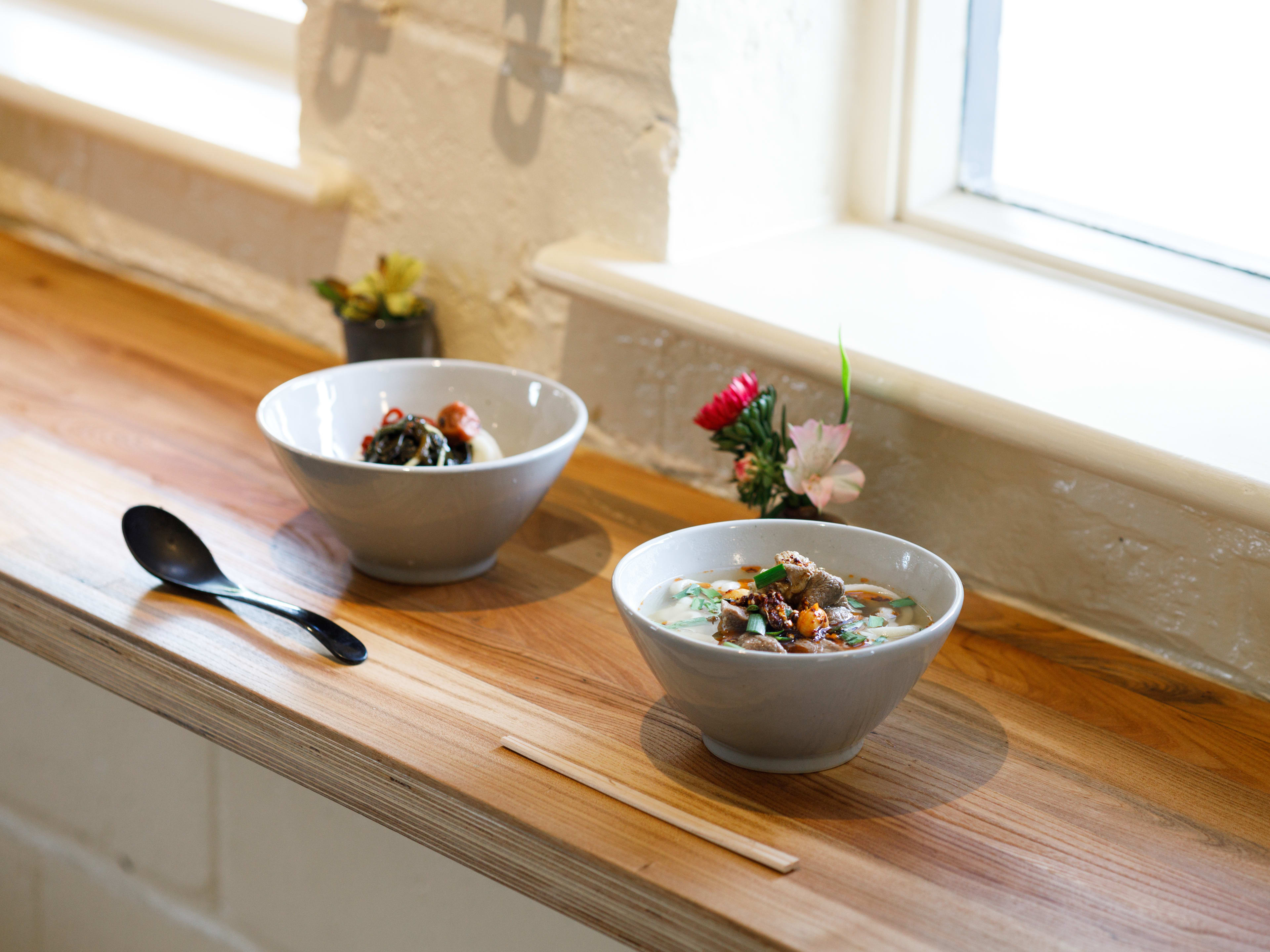 Two bowls of udon from Koya Ko on a window counter.