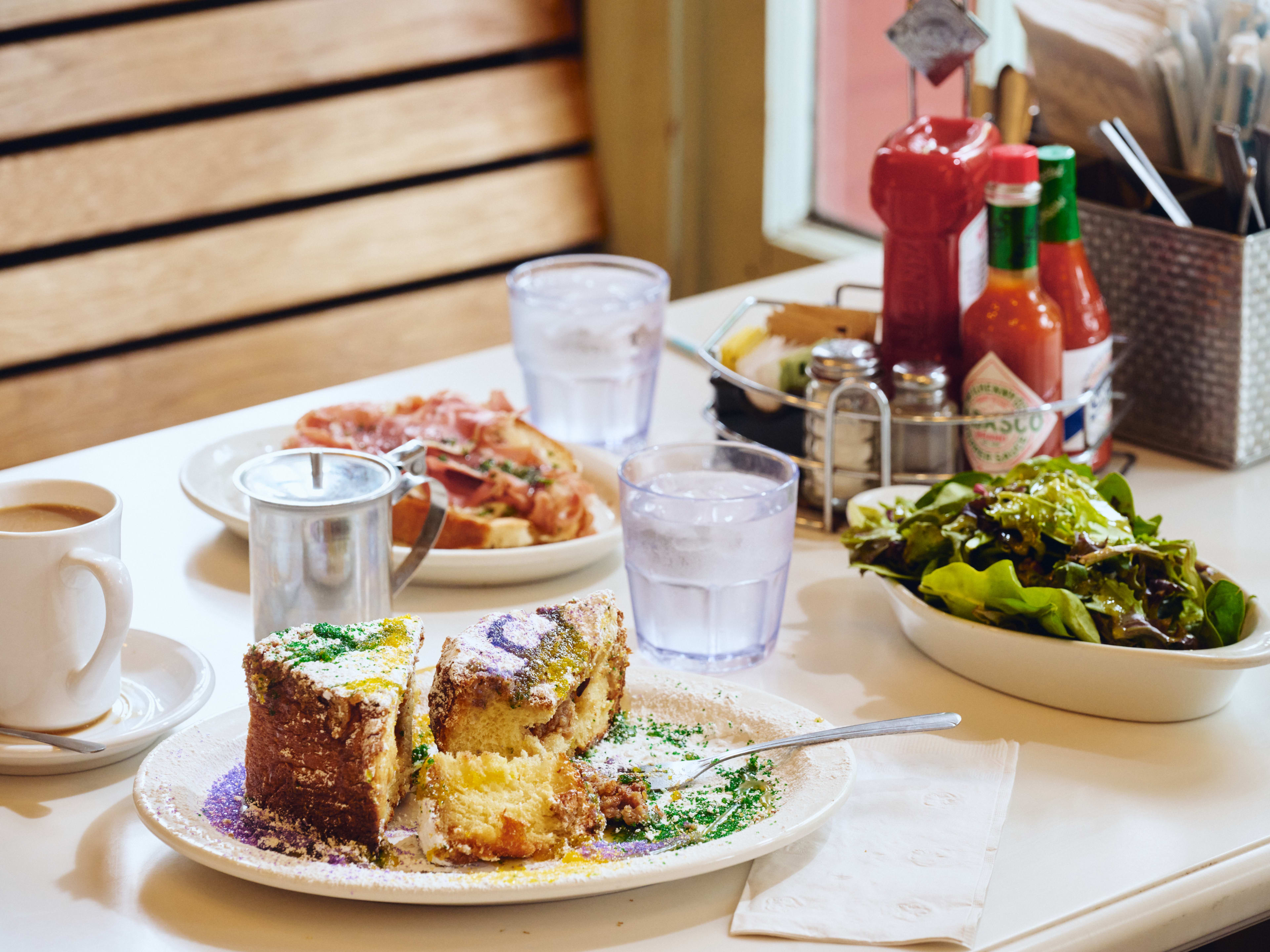 Spread of breakfast dishes including Mardi Gras French toast at Toast