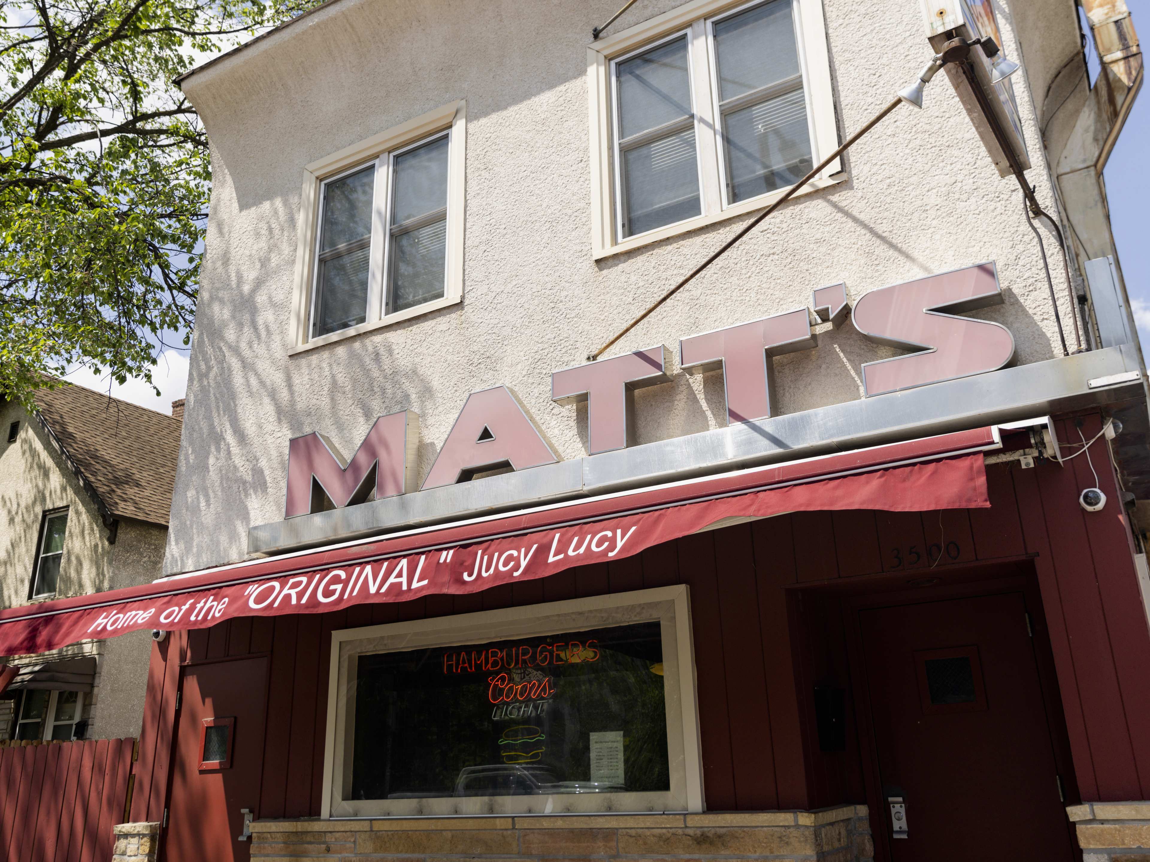 Exterior of Matt's Bar with red signage