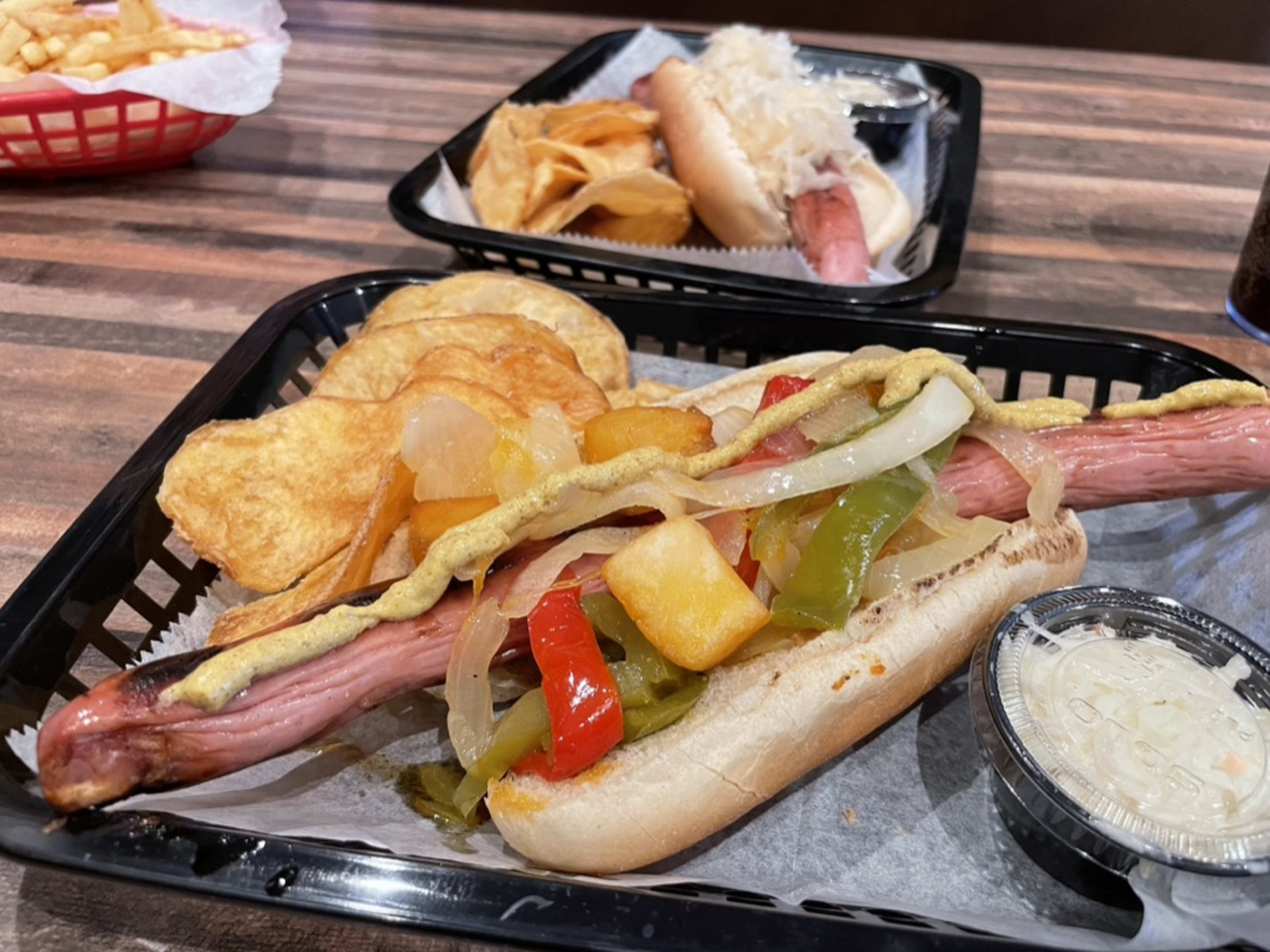 Max's Bar & Grill hot dog on a plastic tray with chips and slaw