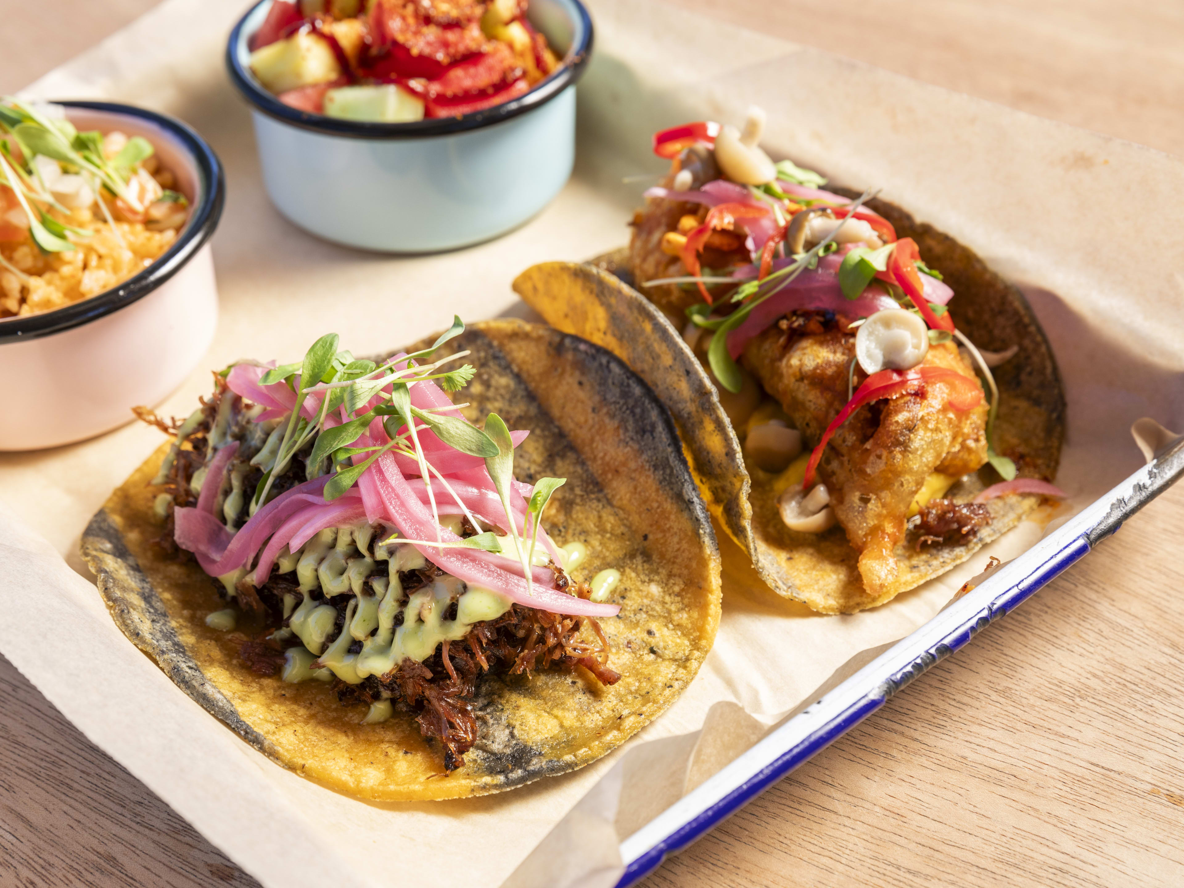 a barbacoa taco and a fried mushroom taco at Maximo Canteen on yellow and blue corn tortillas with sides of mexican rice and stewed lentils