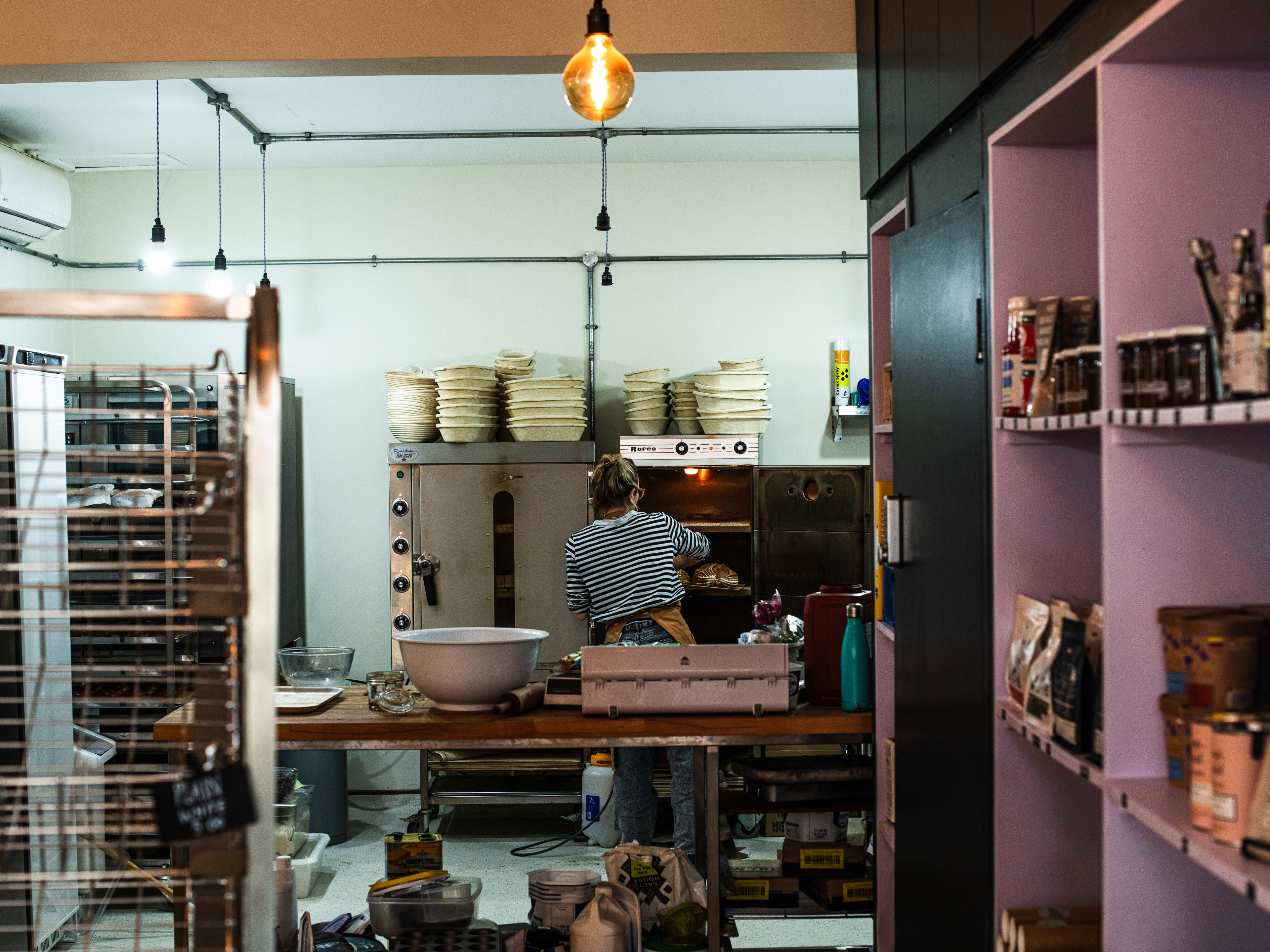 A pastry chef from Maya’s Bakehouse works in the kitchen.