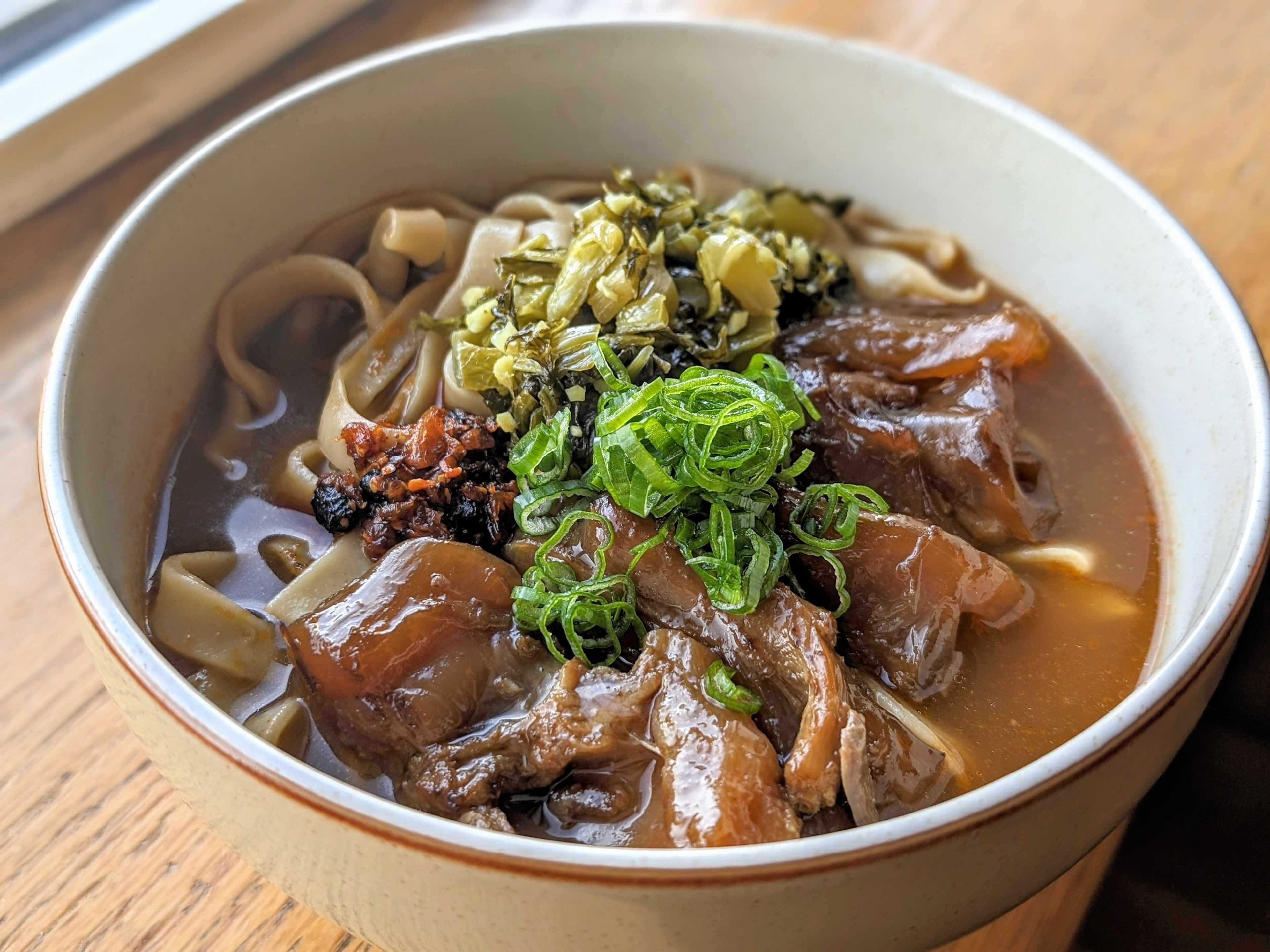 Bowl of noodle soup with lots of toppings