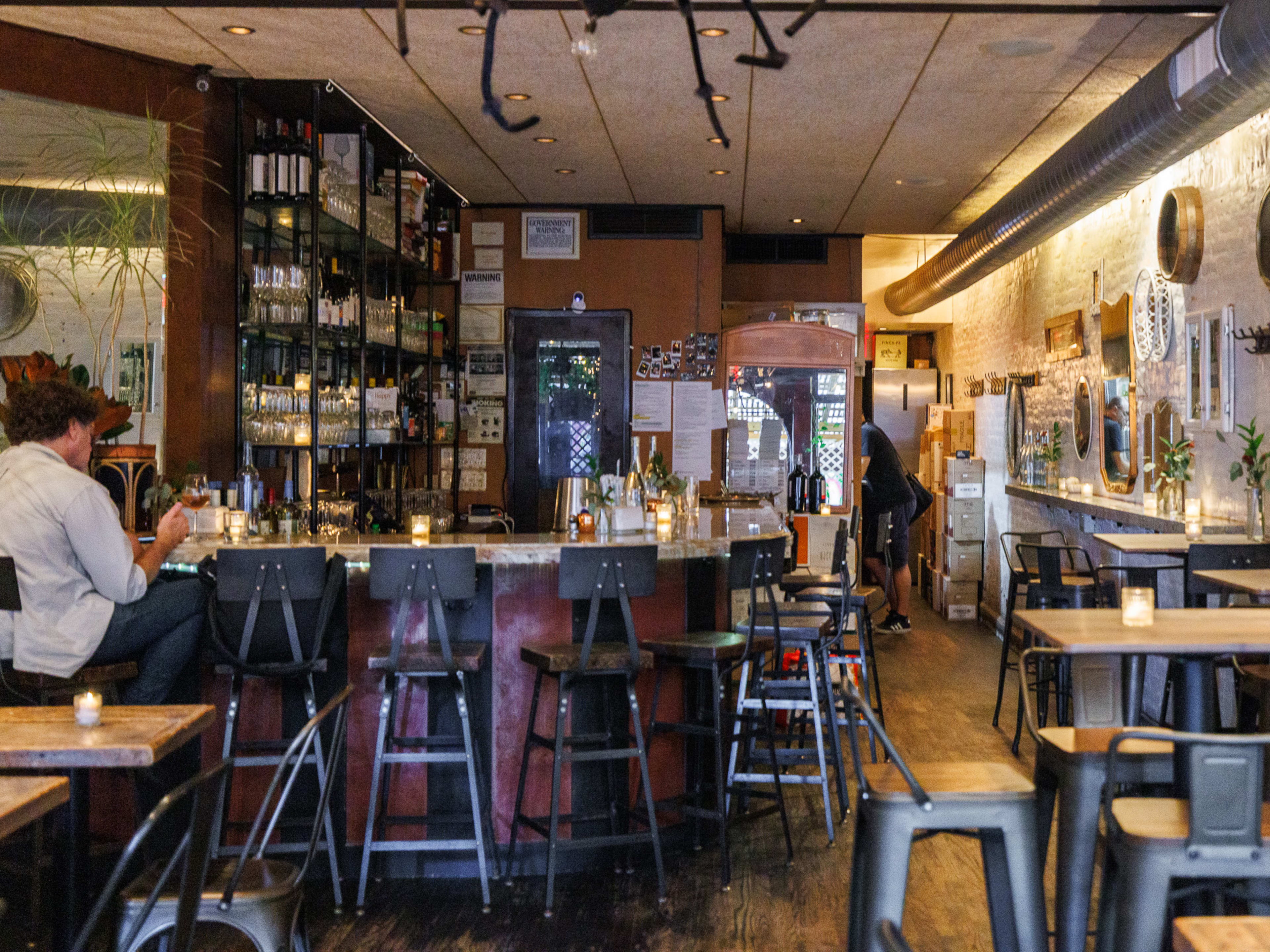 Interior at bibi with high top tables and bar seating