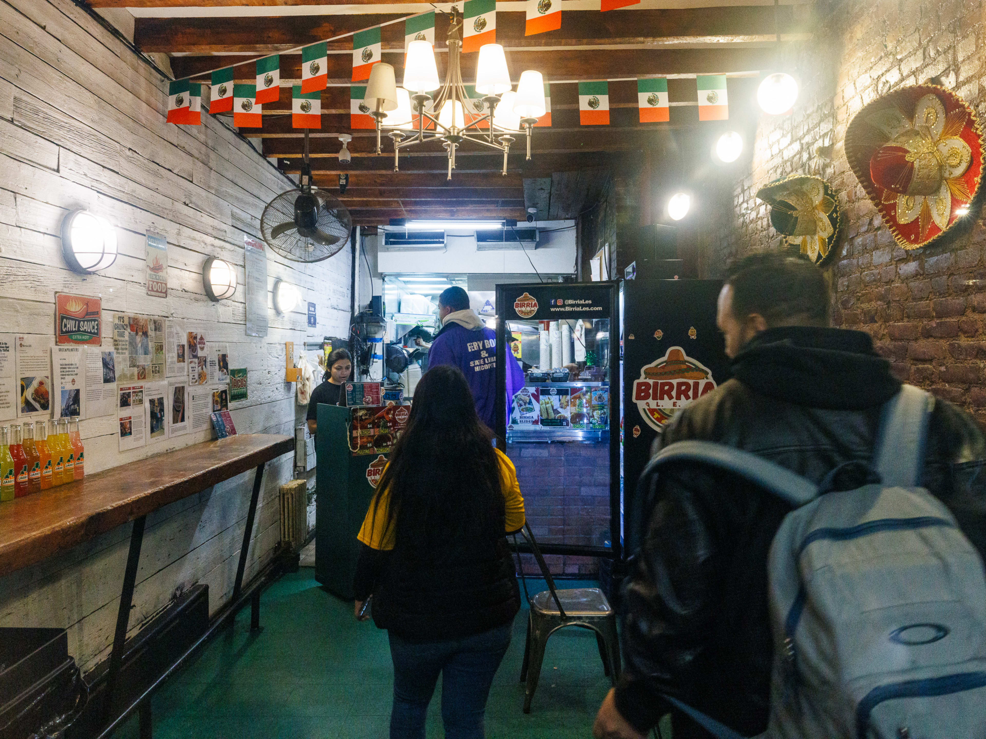 Birria LES interiors with people standing in line to order at the counter