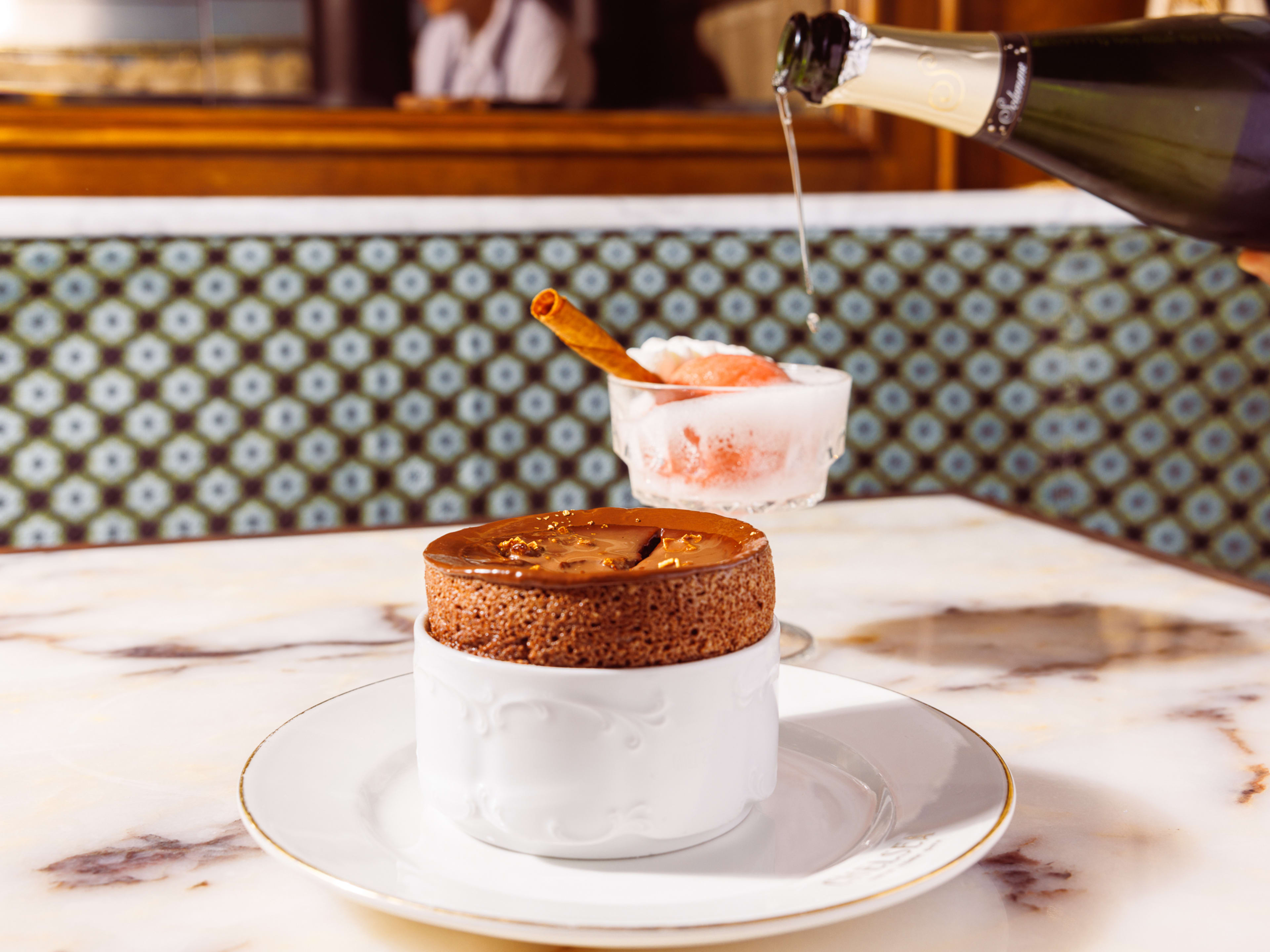 chocolate souffle and strawberry sorbet with a champagne pour