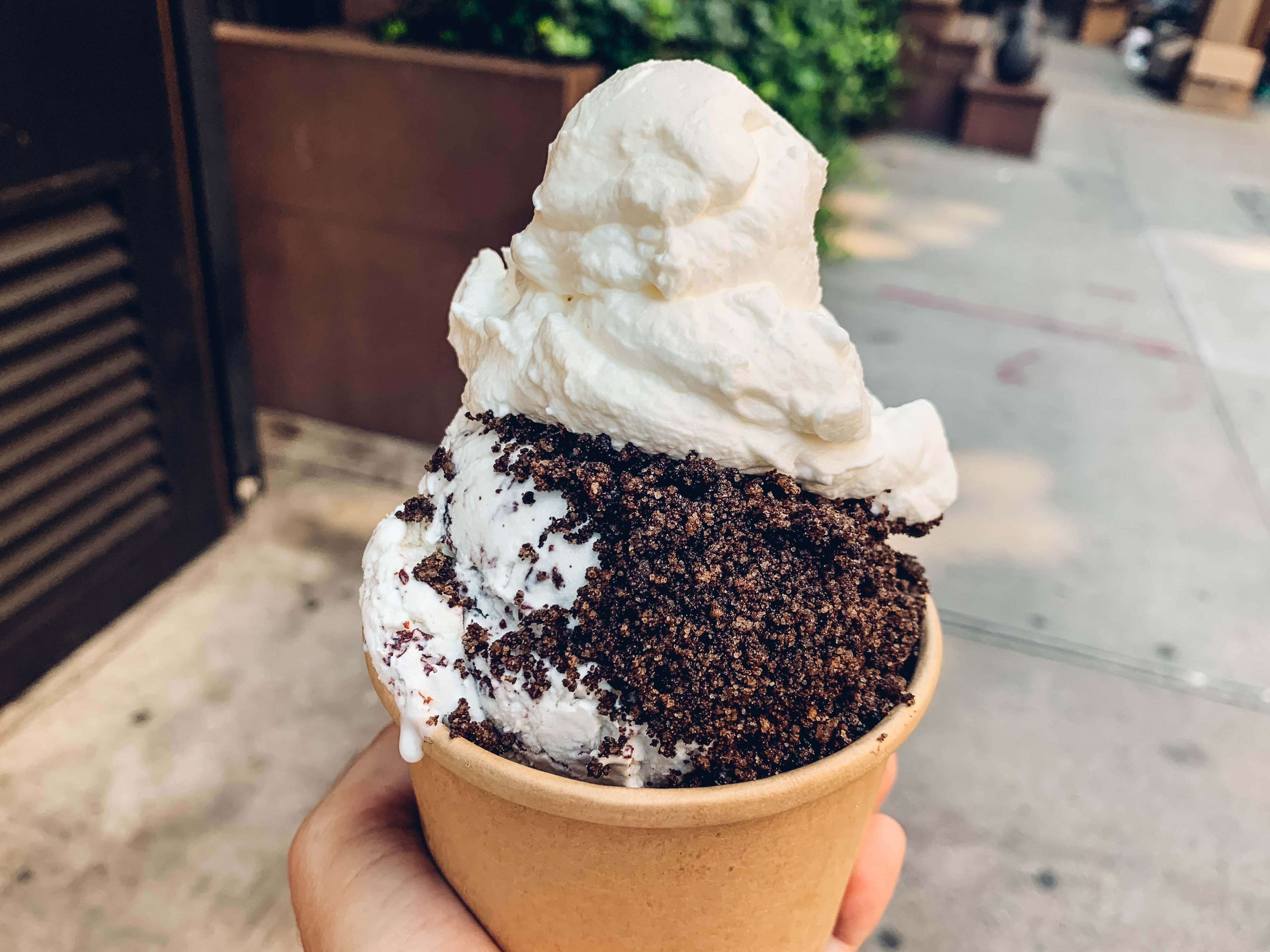 Caffè Panna ice cream with toppings in a cup held up on the street