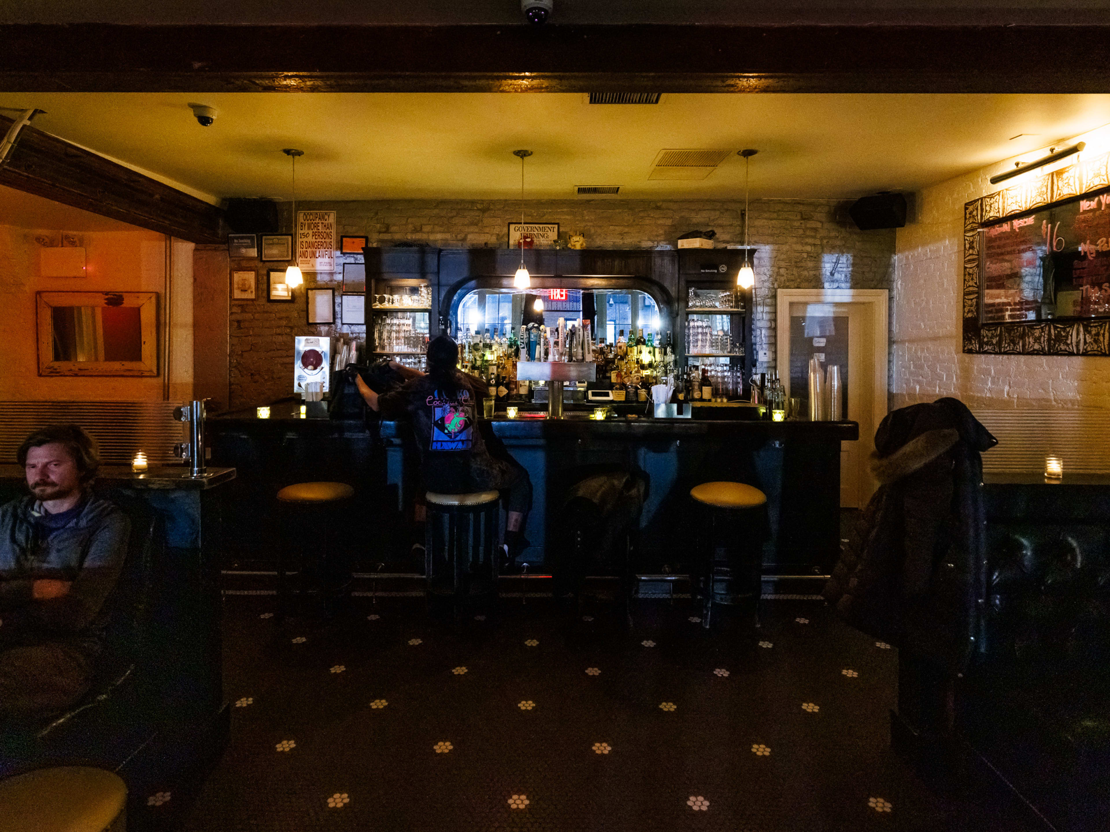 Dream Baby interior with dim lighting and people sitting at the bar