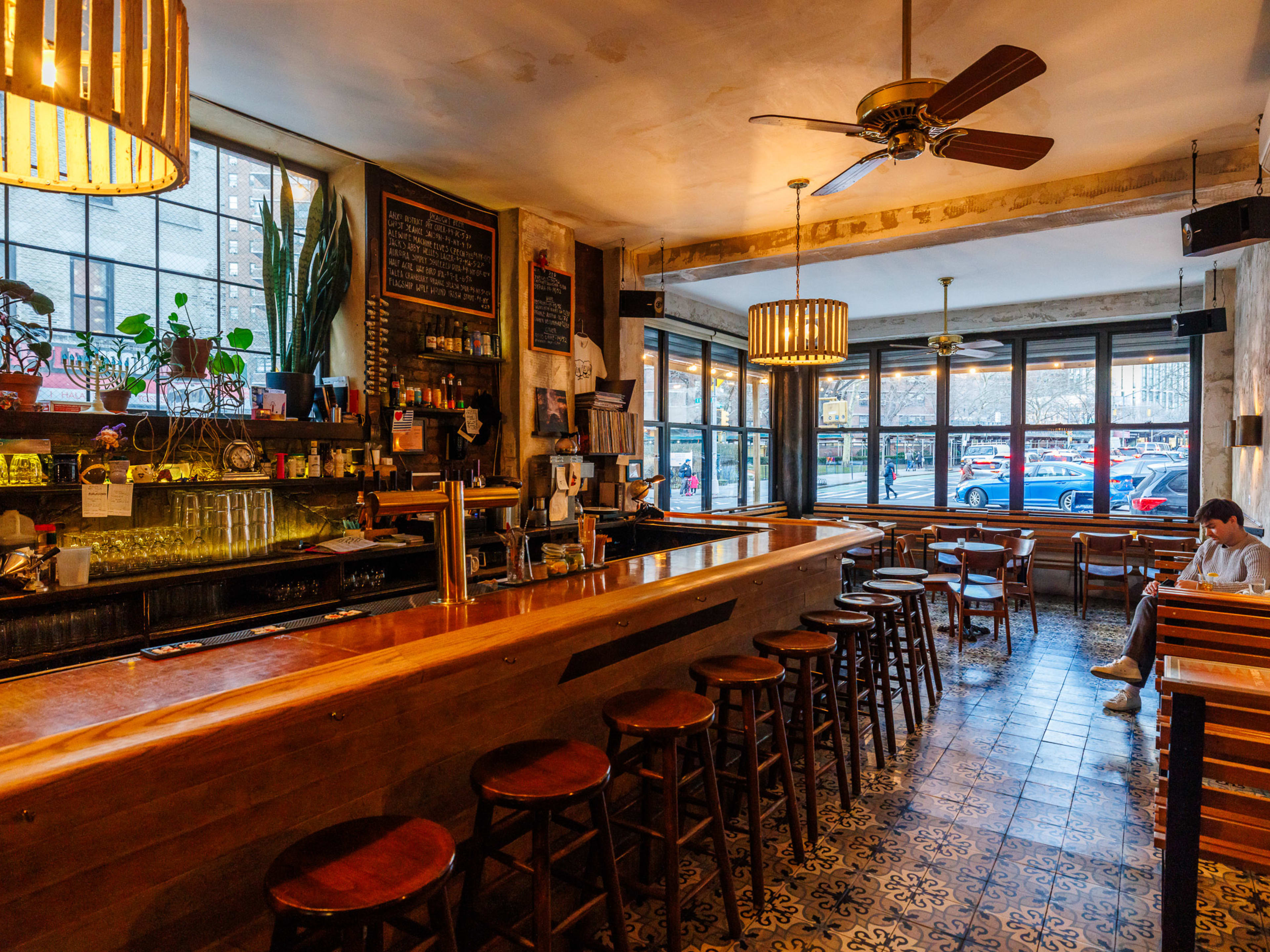 Eastwood interiors with a long wooden bar and a wall with large windows