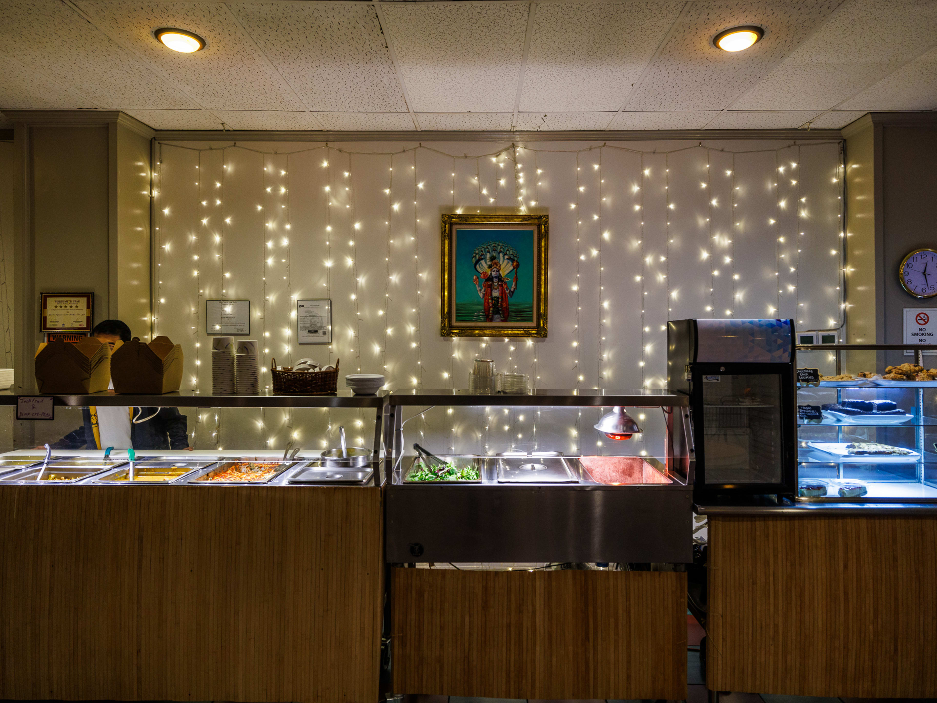 Govinda’s Vegetarian Lunch interior with buffet line and string lights hanging down the walls