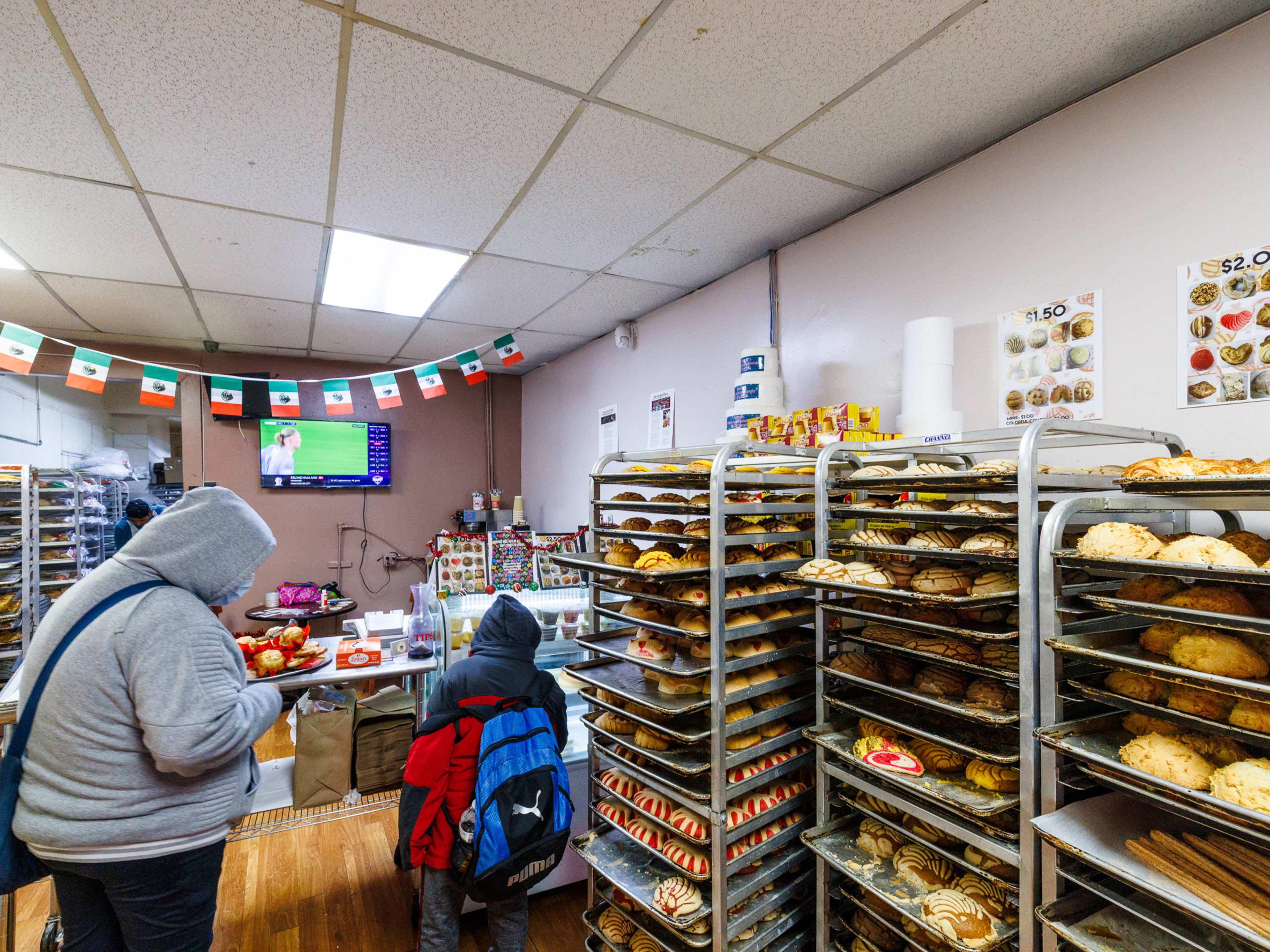 Guadalupana Mexican Bakery interior with baked goods displayed on baking sheet shelves