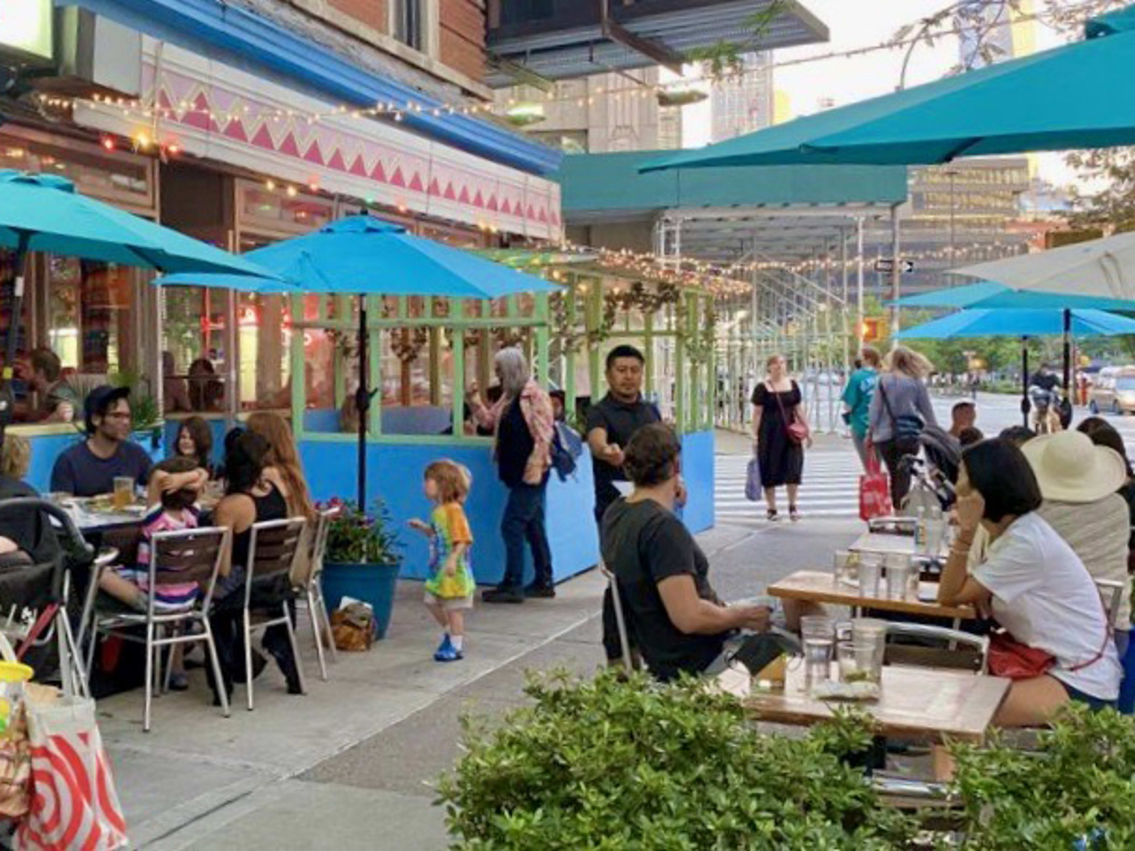 Lupe's East LA Kitchen exterior with outdoor sidewalk seating and umbrellas