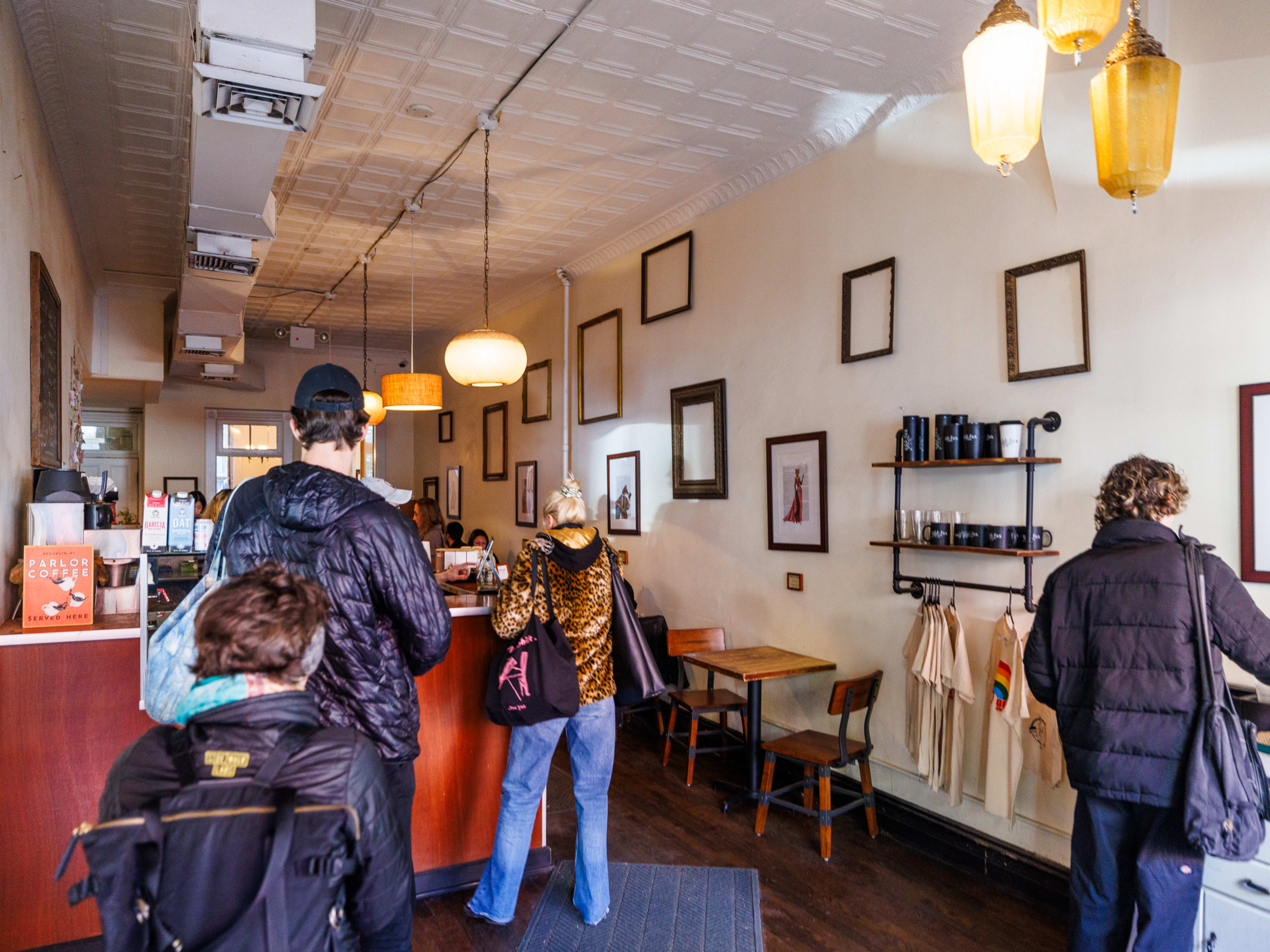 Odd Fox interior with people ordering at the counter and frames displayed on the wall