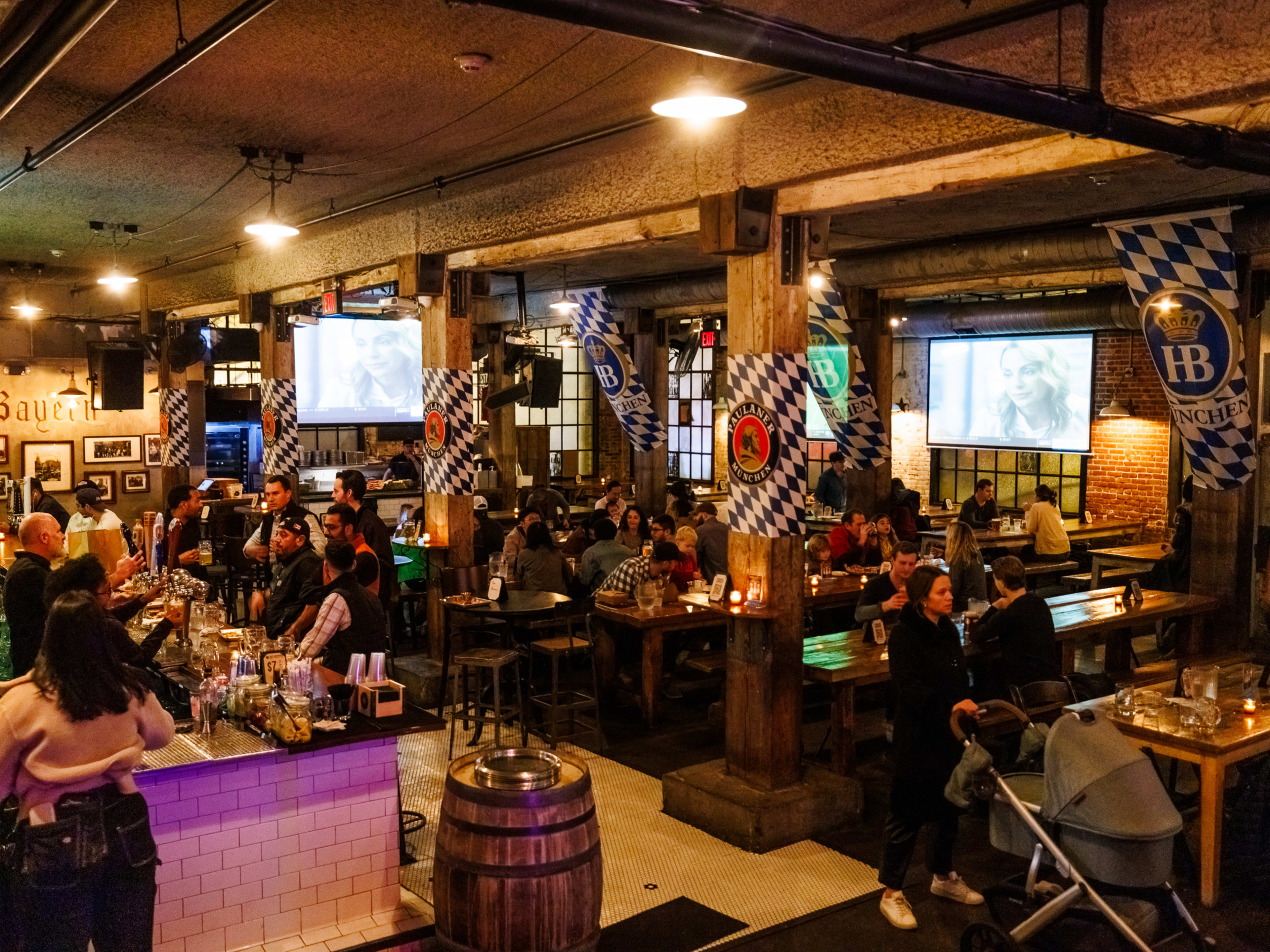 Pilsener Haus & Biergarten interiors filled with long wooden communal tables filled with people