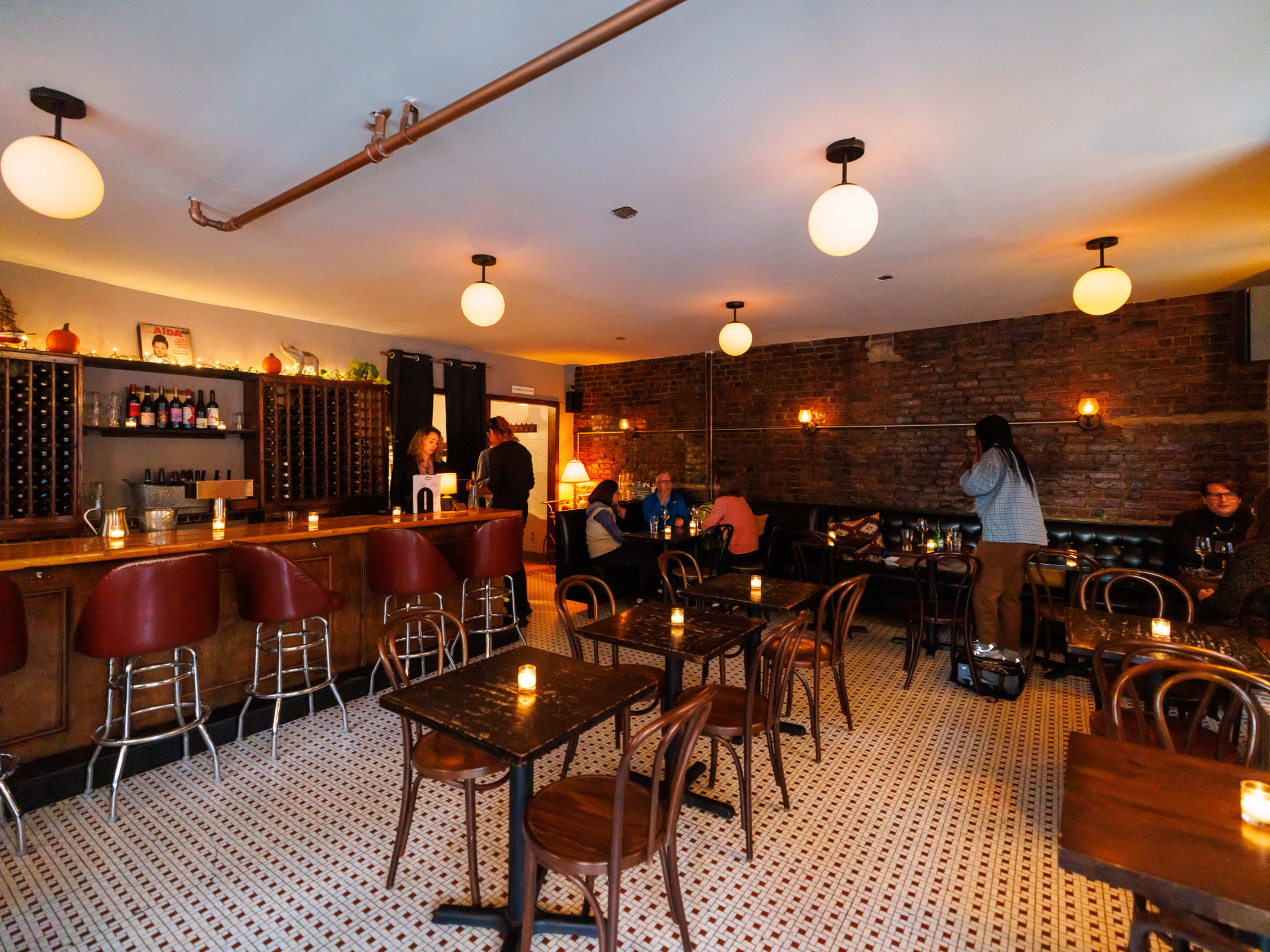 Interior at Pinkerton Wine Bar with wooden tables with candles on them