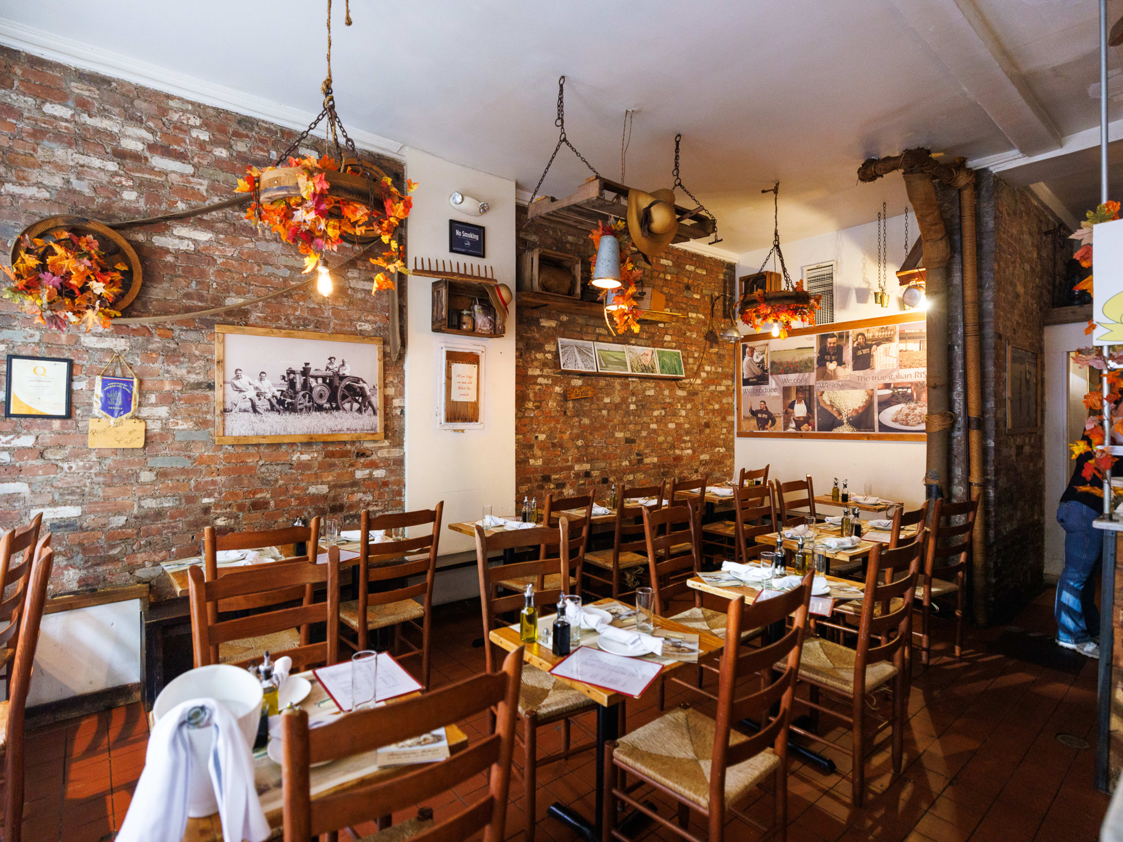 Interior at Risotteria Melotti with brick walls and wood tables and chairs