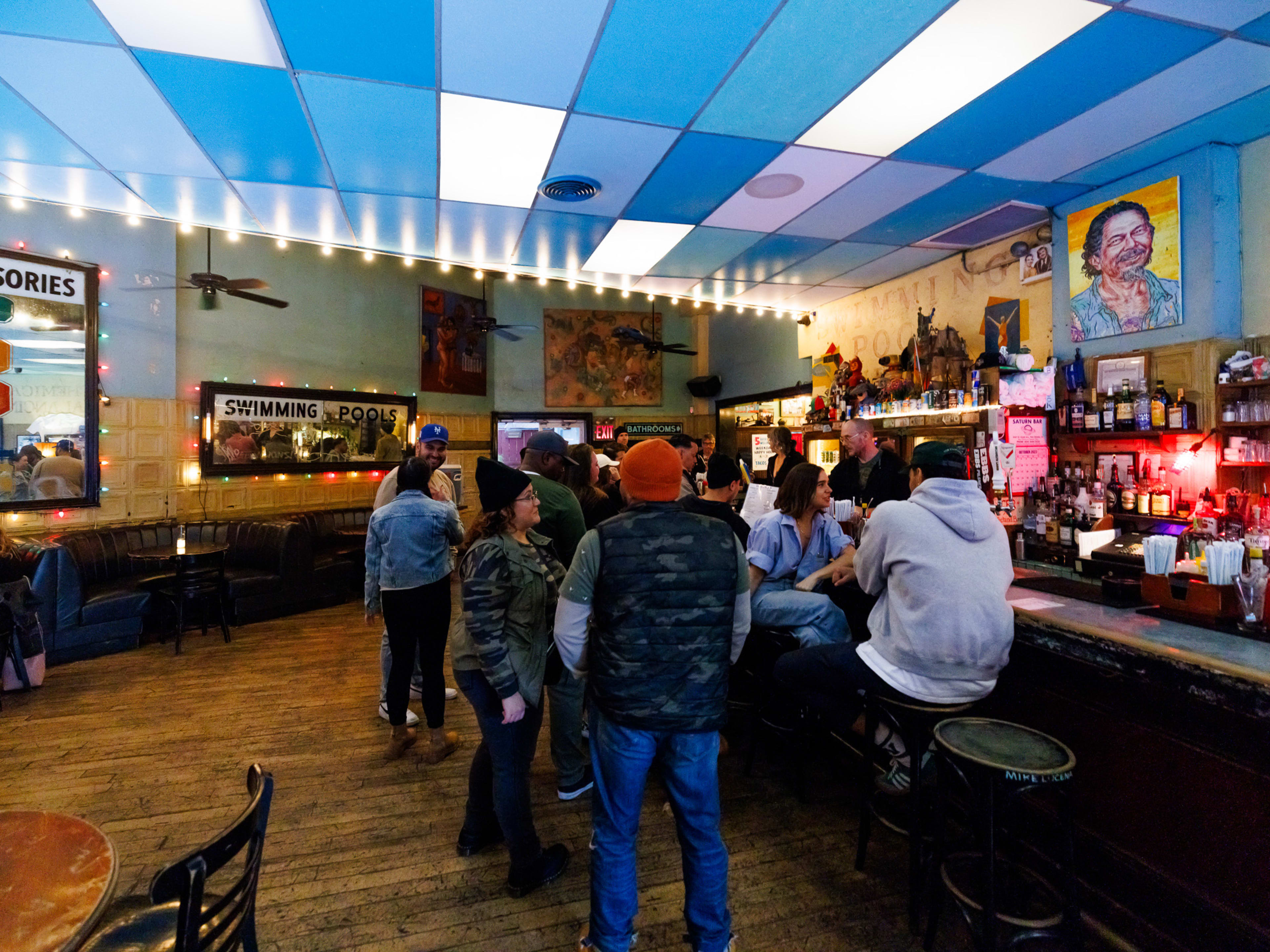 Interior at Union Pool with bar seating and a colorful tiled ceiling