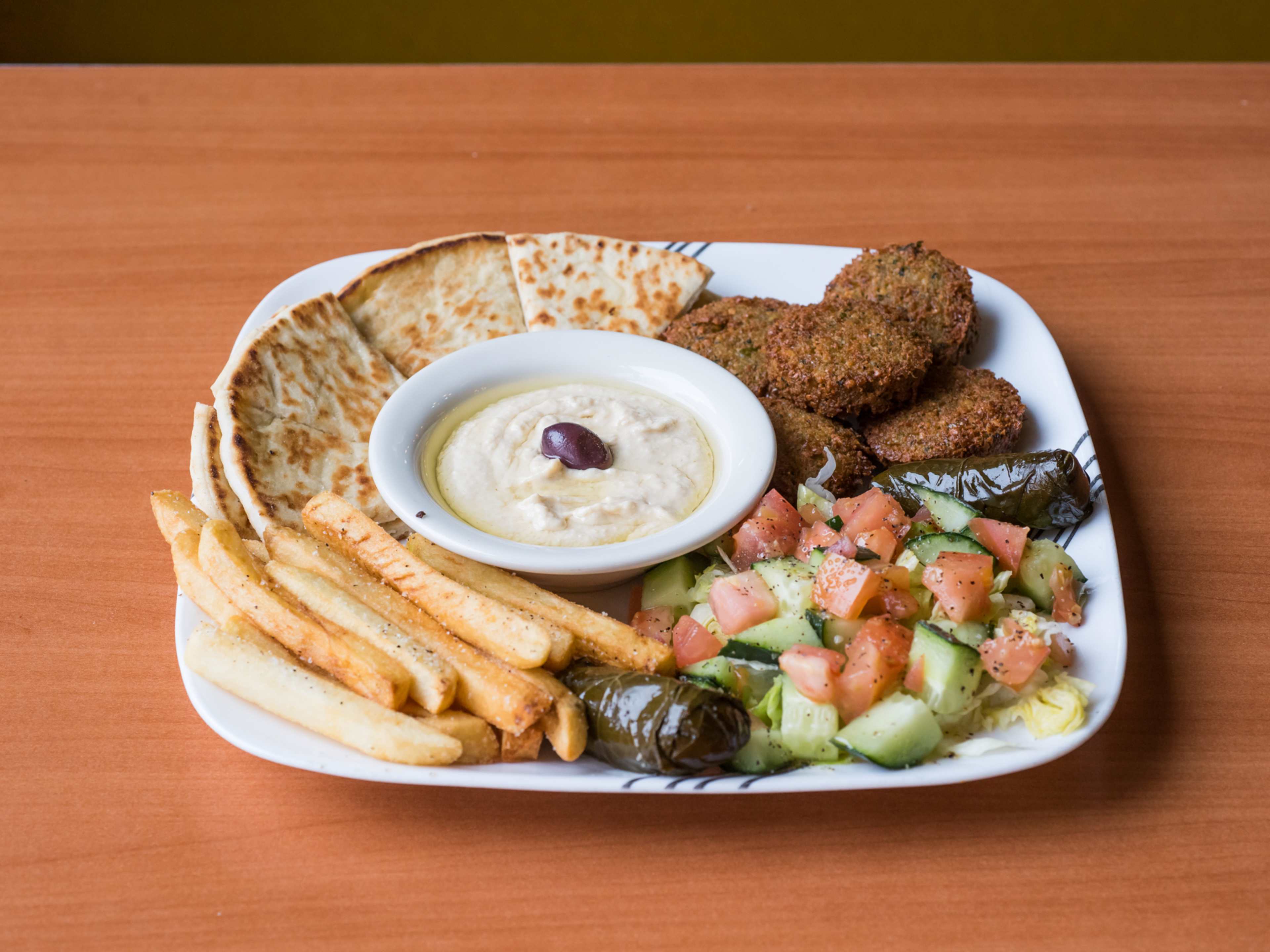 falafel platter with pita, hummus, and cucumber tomato salad