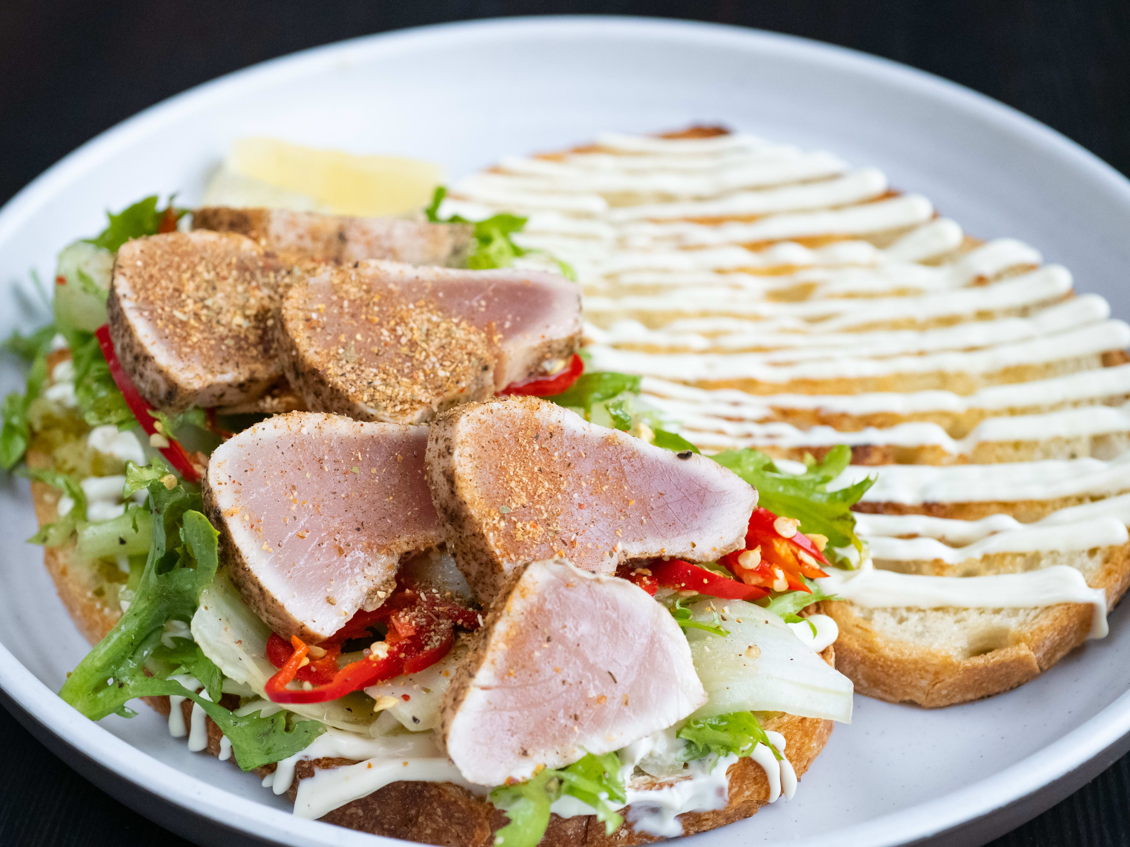 open-faced sandwich with albacore tuna, a drizzle of mayo, and fresno chili.