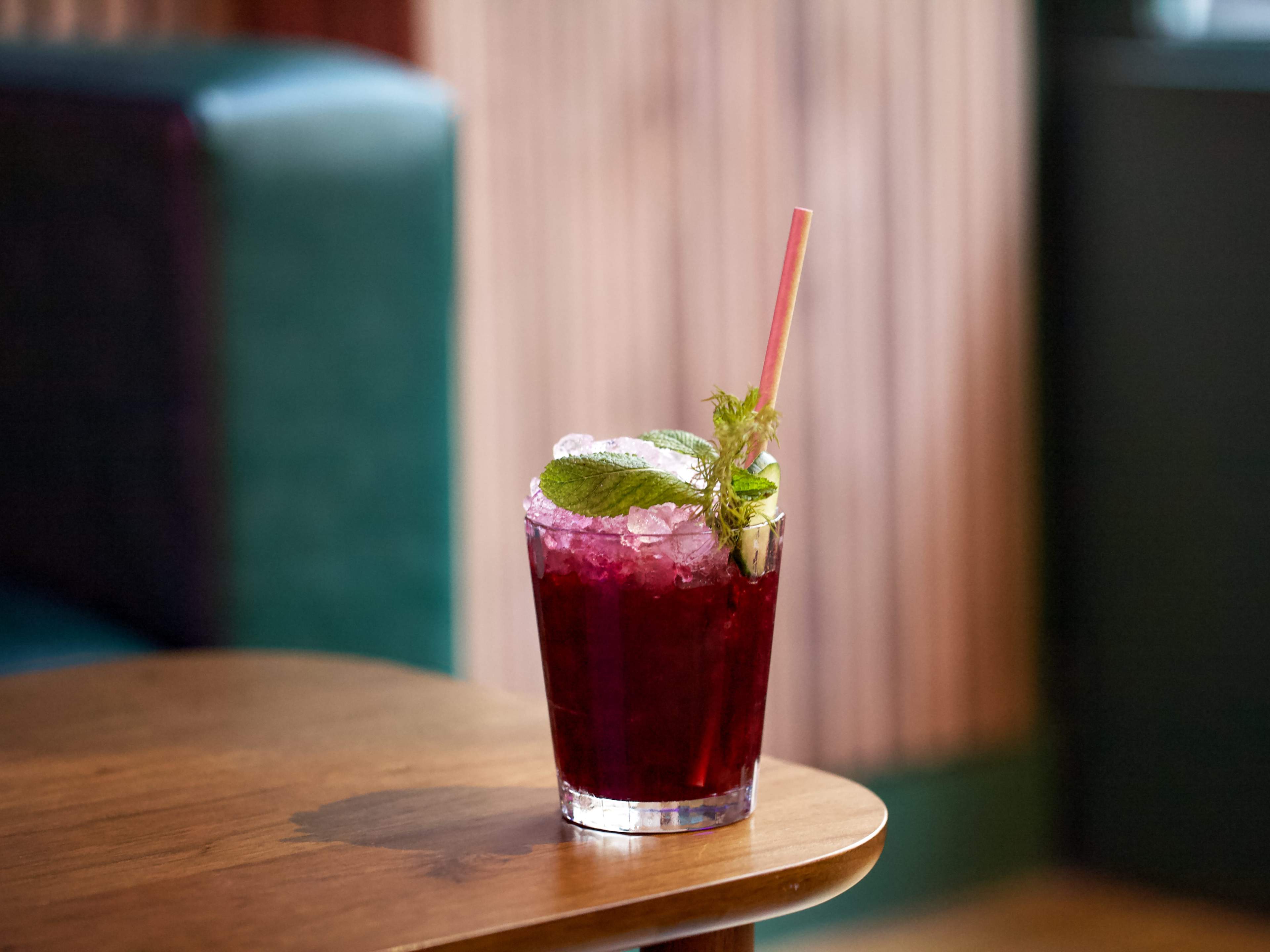 Deep red cocktail served over ice at The Honey Moon