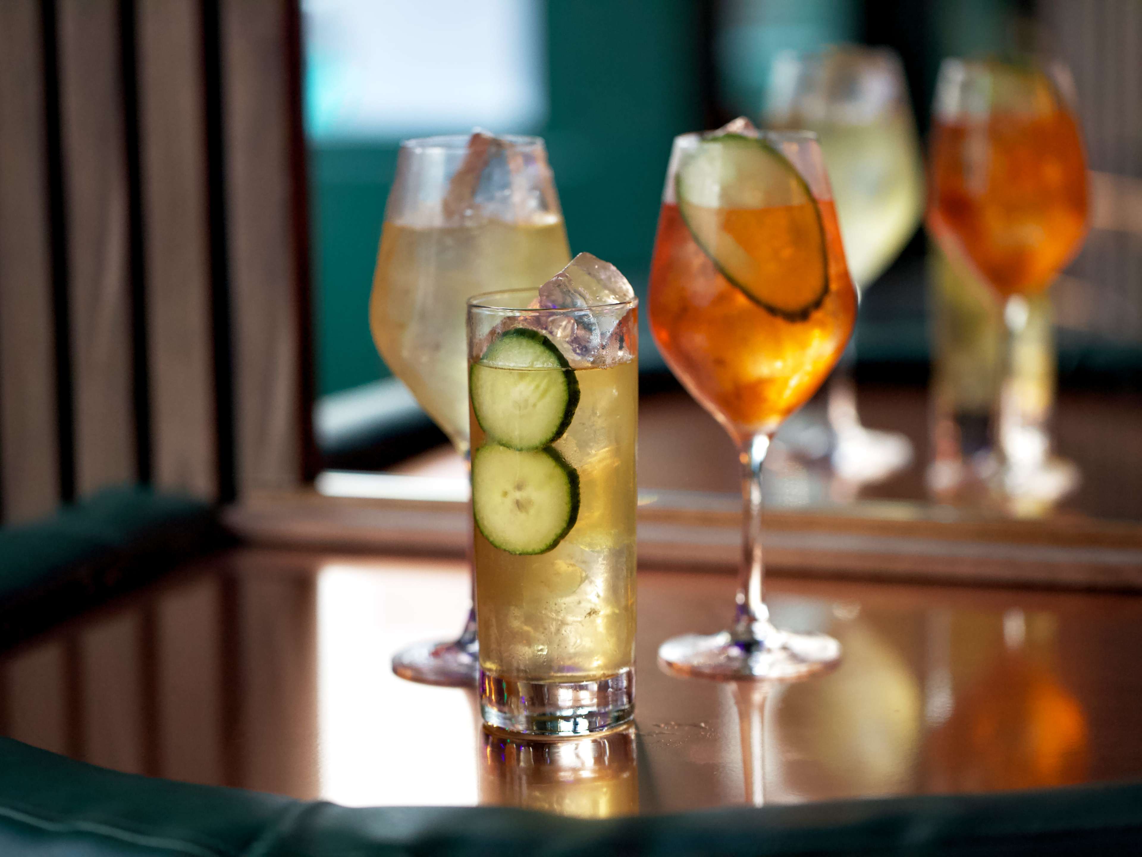 Spread of cocktails on wooden table at The Honey Moon