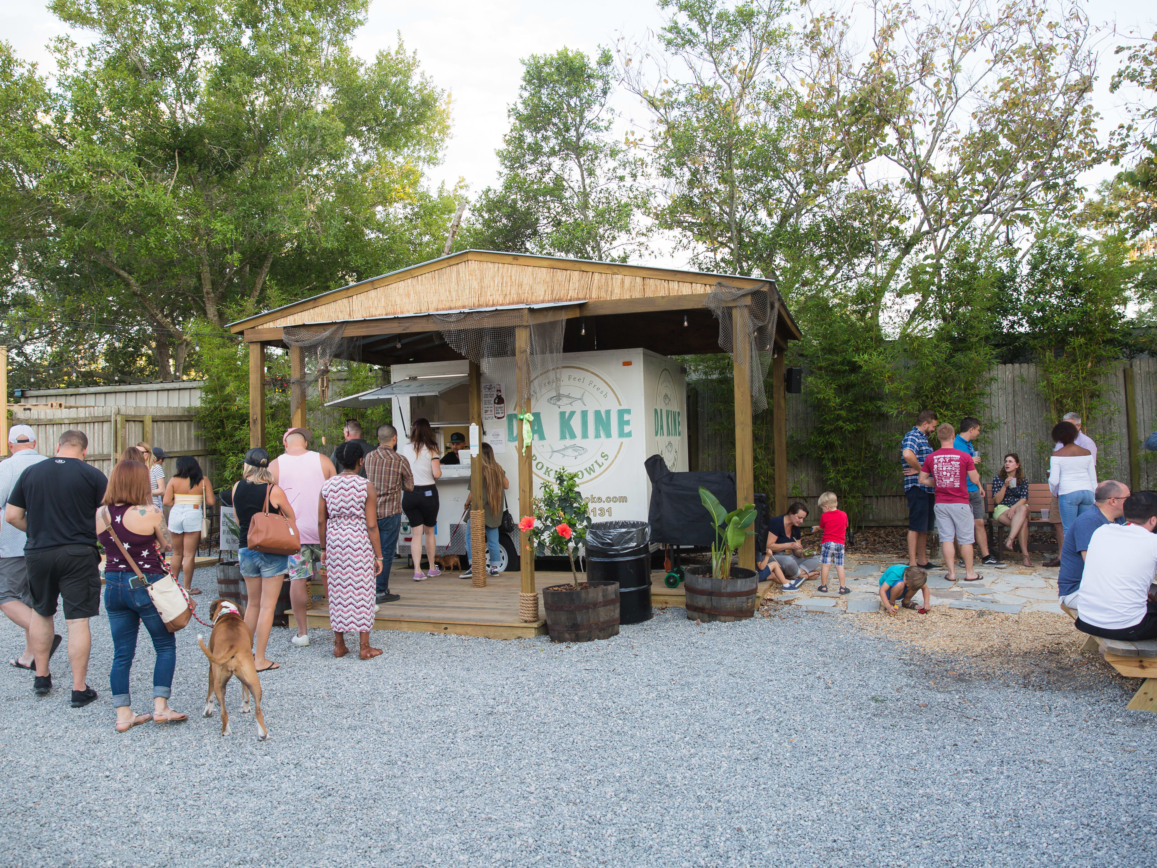 Da Kine Poke outdoor food stall with people waiting in line to order