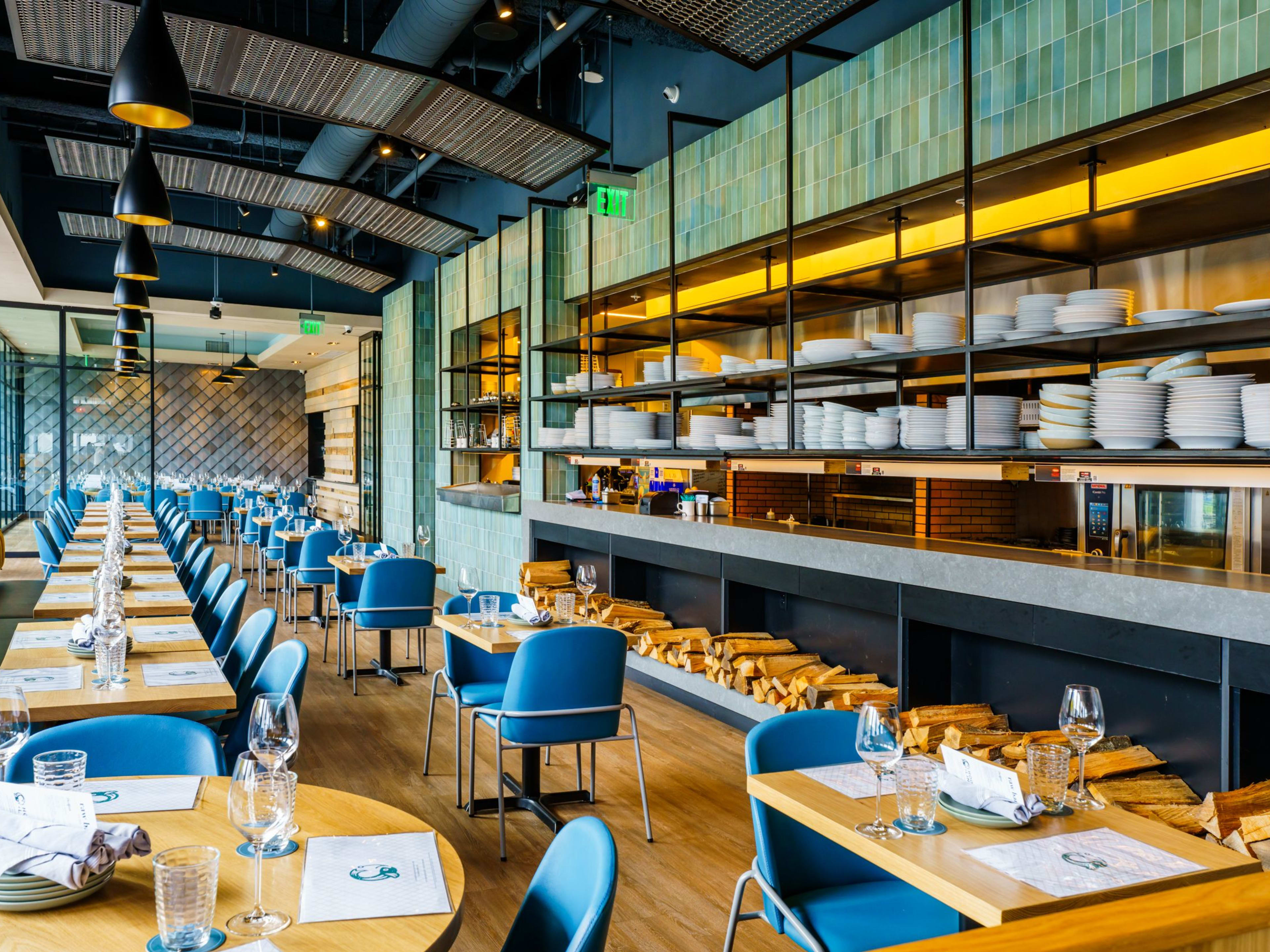 Large interior dining room space with blue accents at Hook & Line