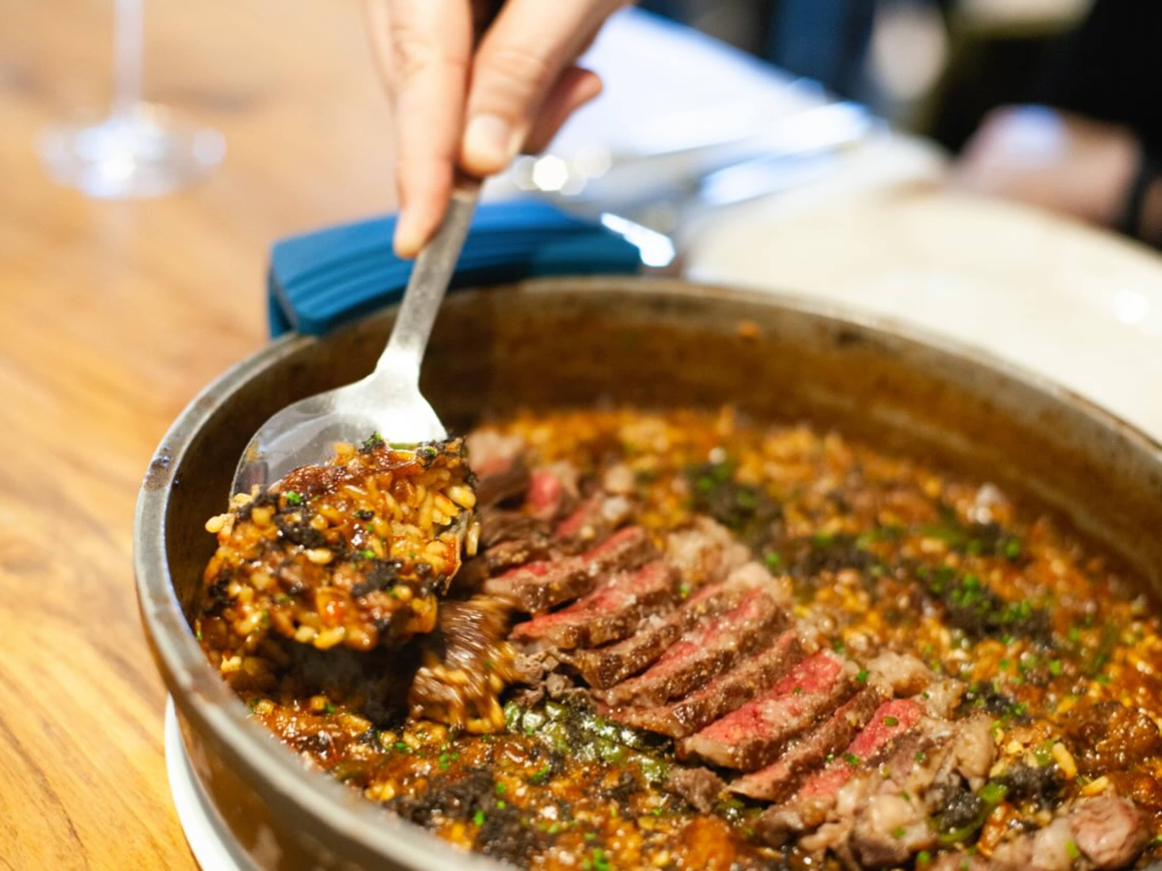 person scooping paella