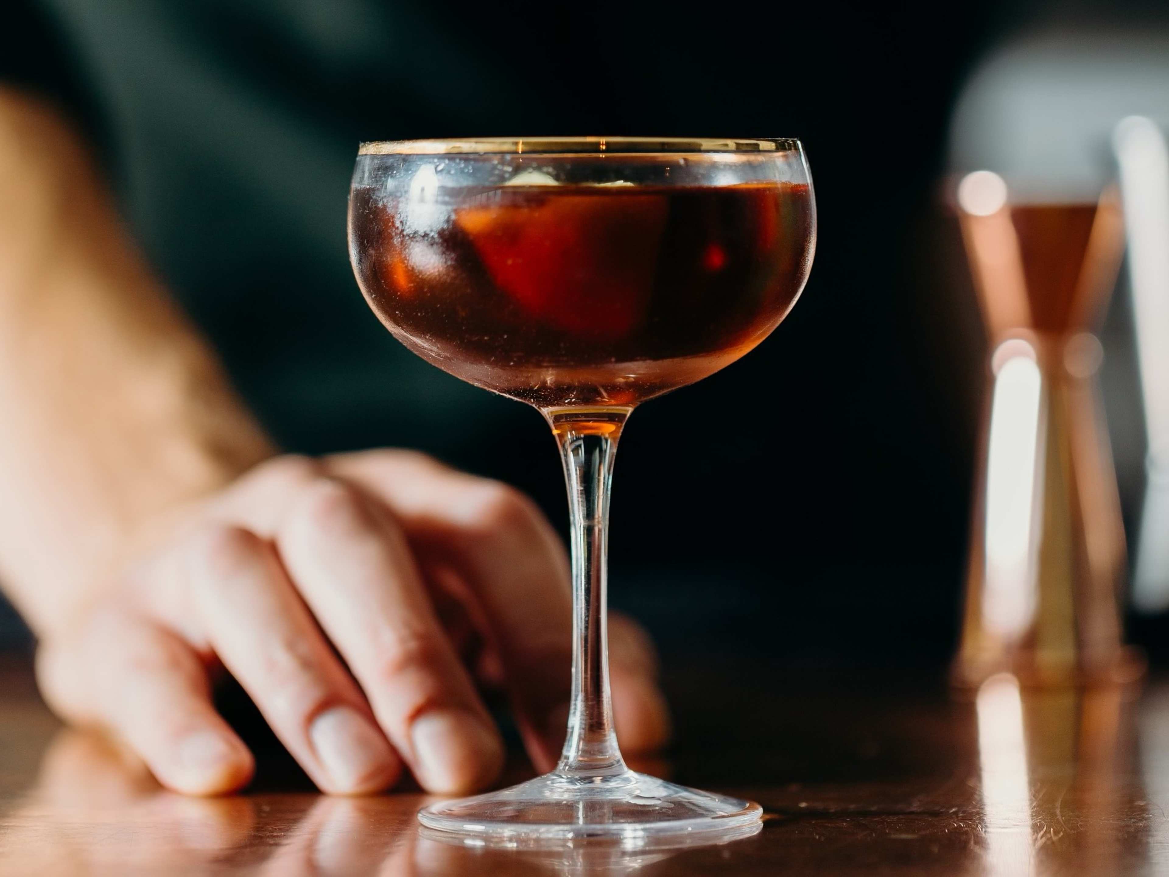 Dark cocktail on bar at Petite Leon