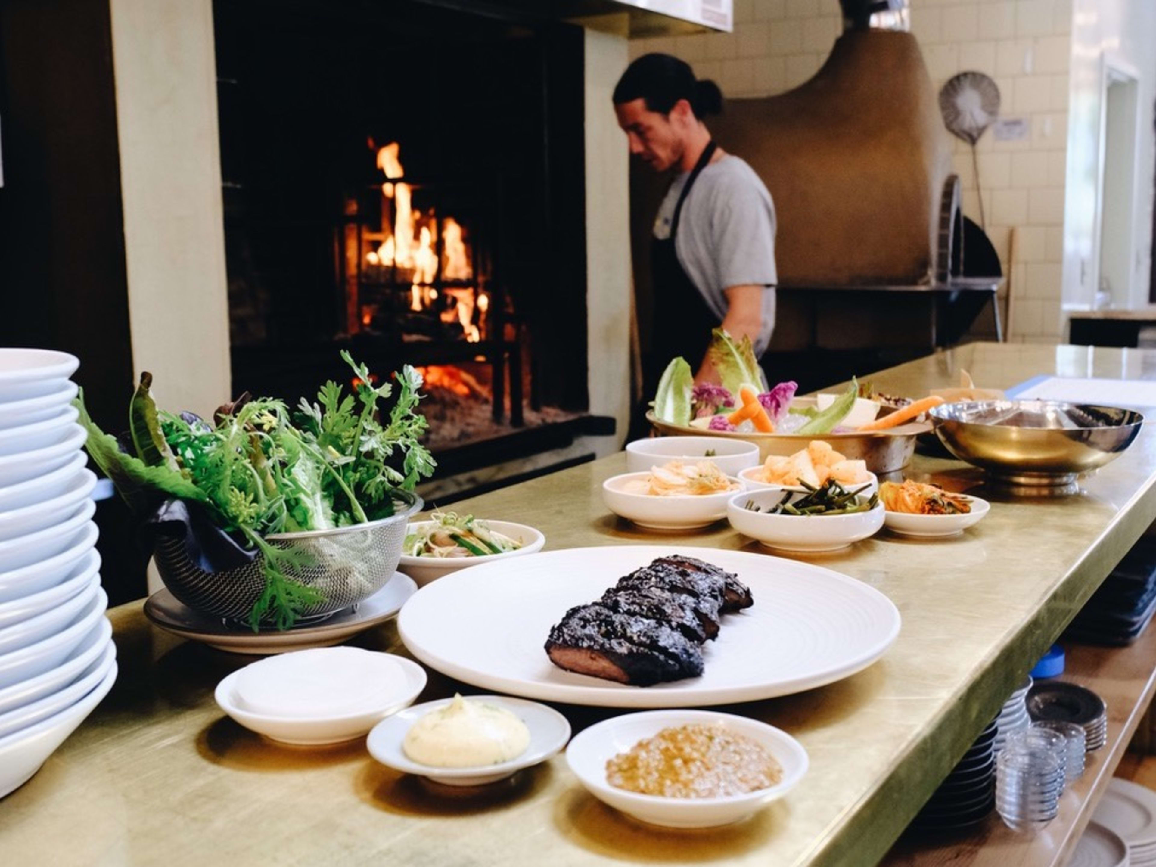 Chef preparing spread of Korean dishes at Jeju