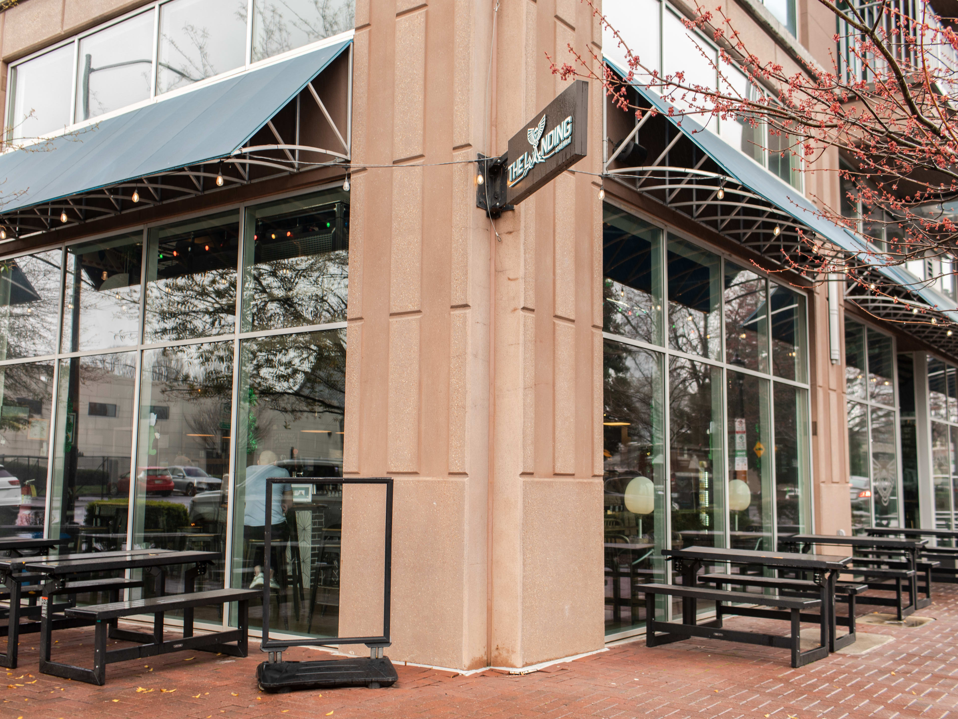 Exterior facade and picnic bench tables at Queen City Grounds.