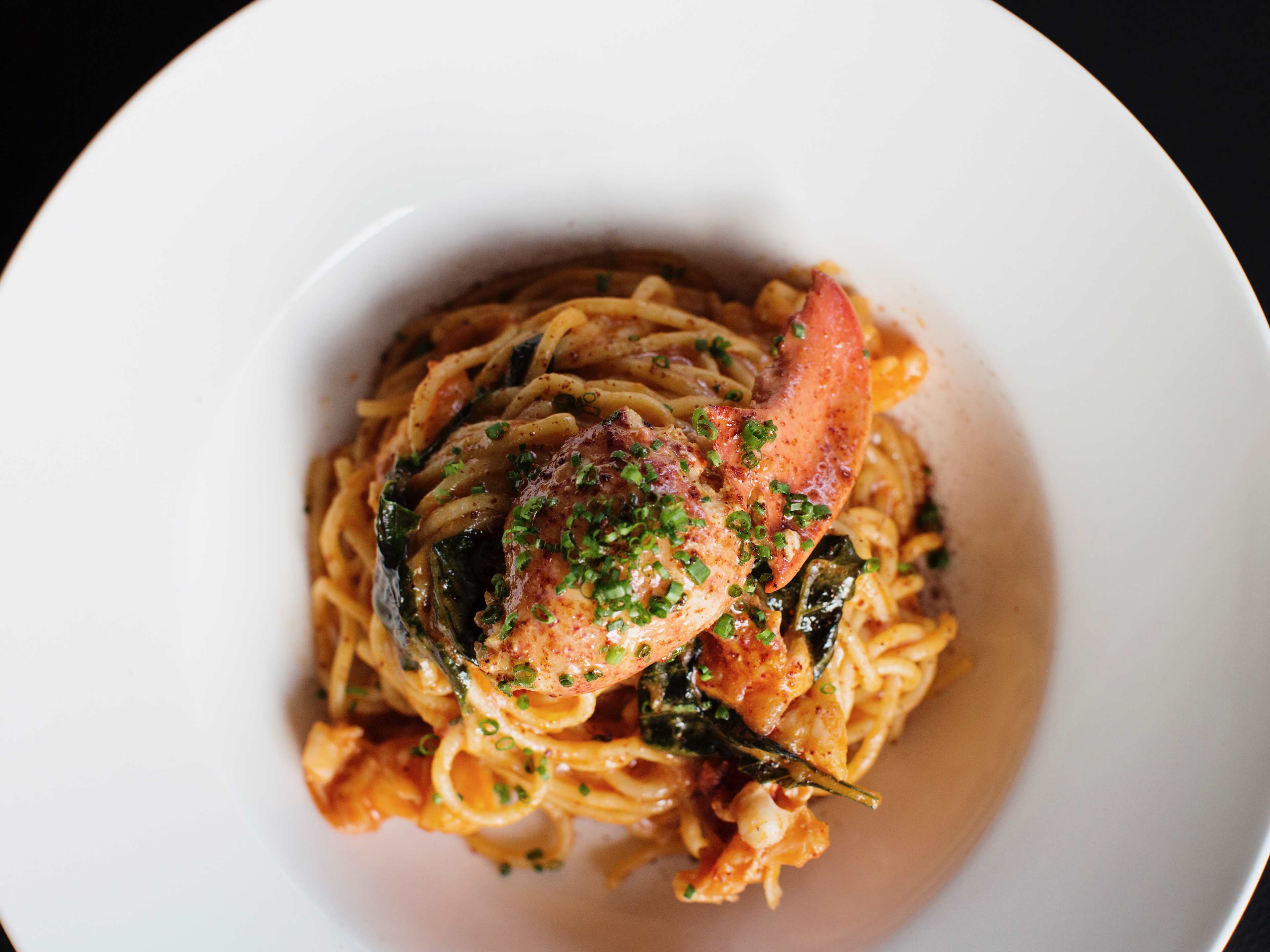 Lobster spaghetti topped with fresh herbs at Martina