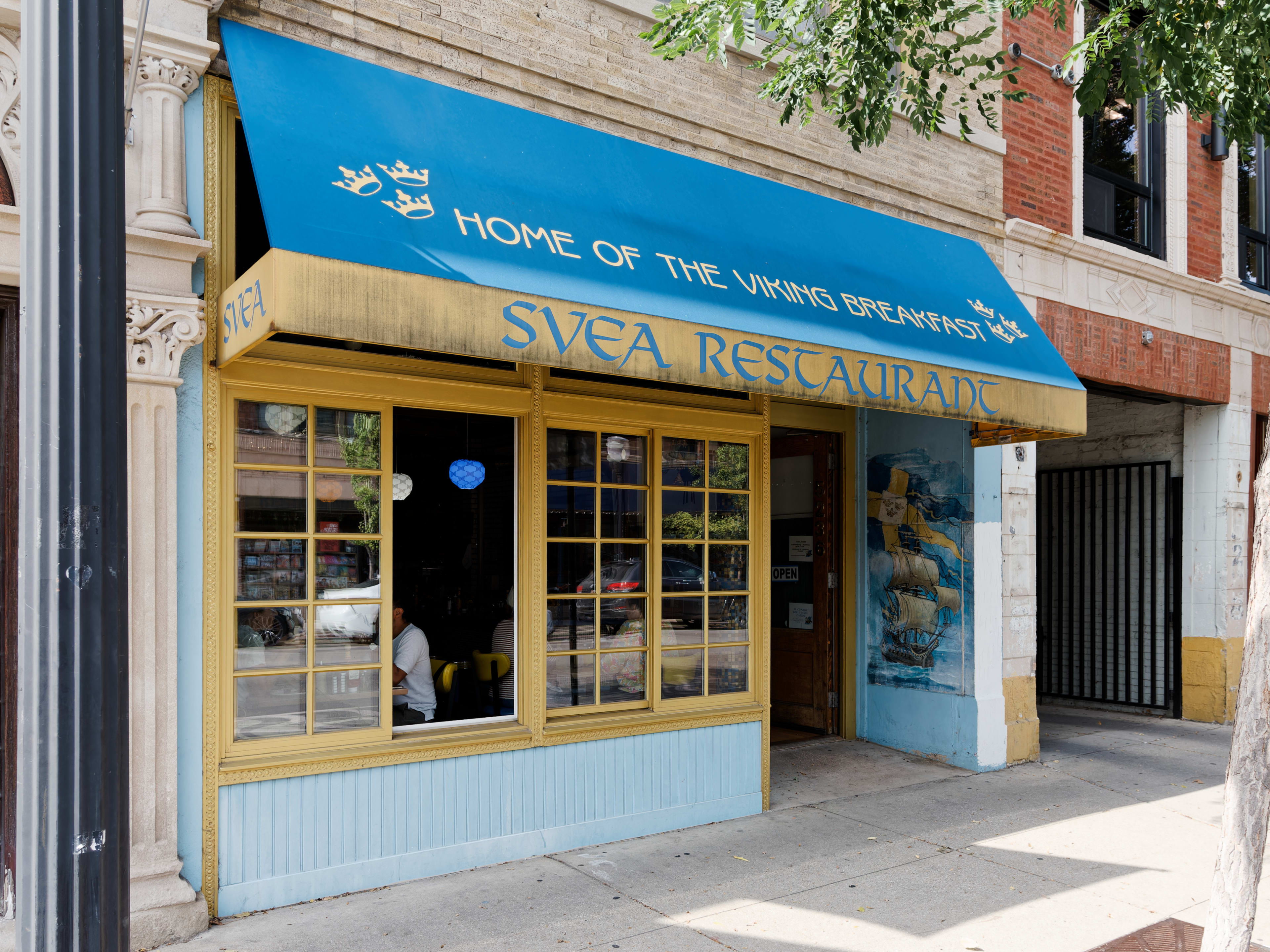 The exterior of Svea Restaurant, a blue and yellow awning that says "Home of the Viking Breakfast."