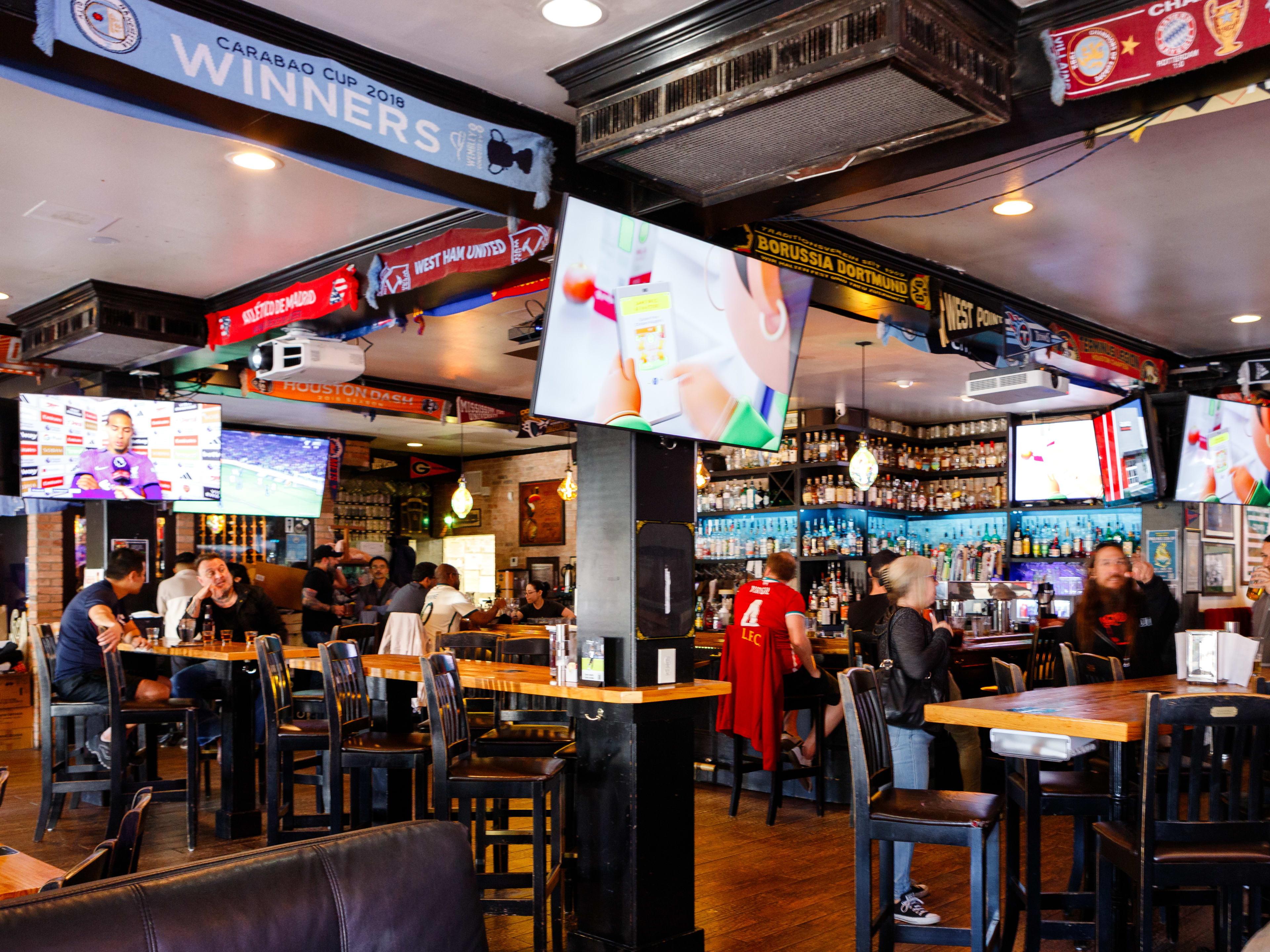 interior of sports pub with dark wood beams and mounted TVs