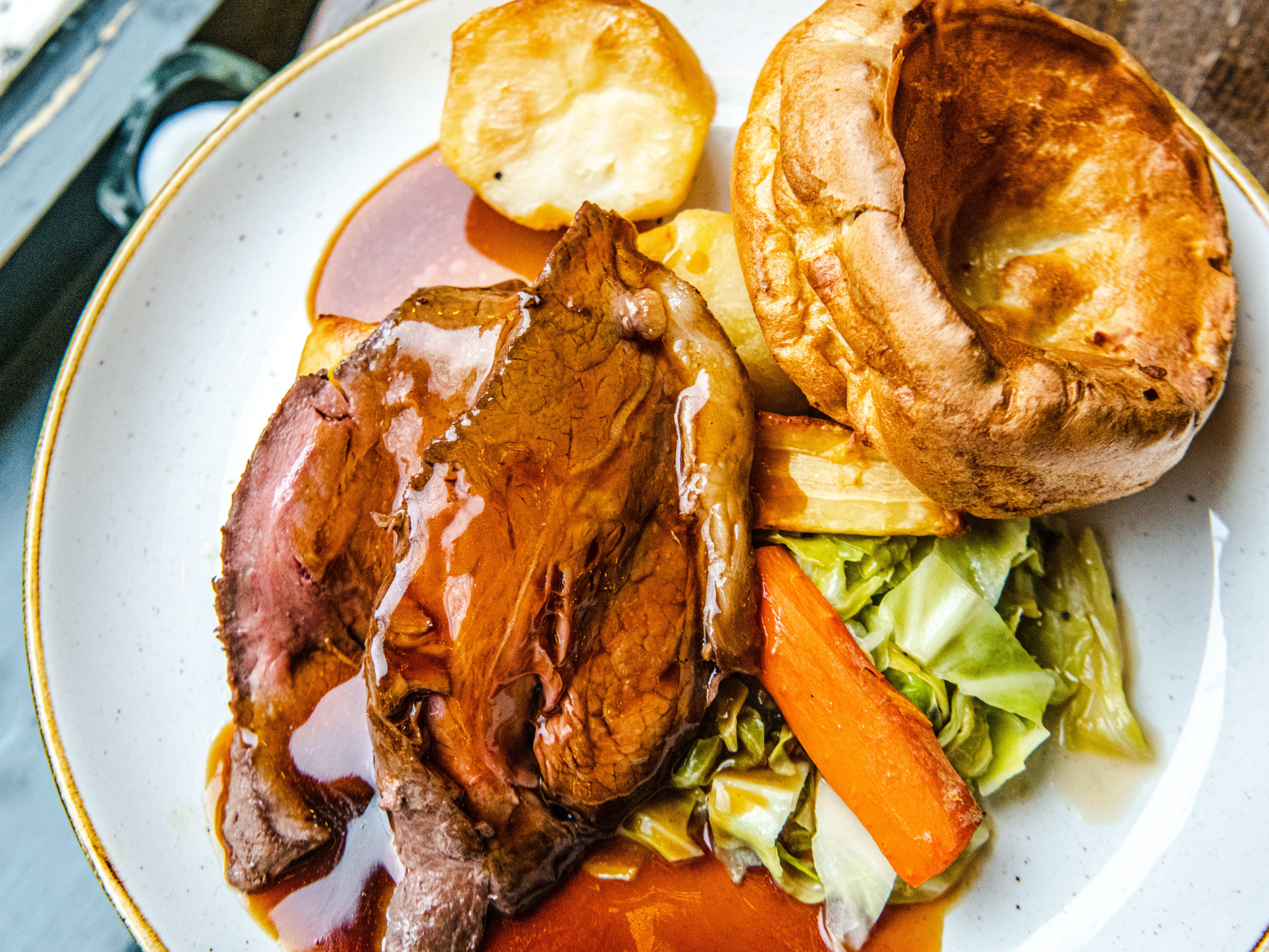 A photo of the beef Sunday roast covered in glistening gravy from The Selkirk.