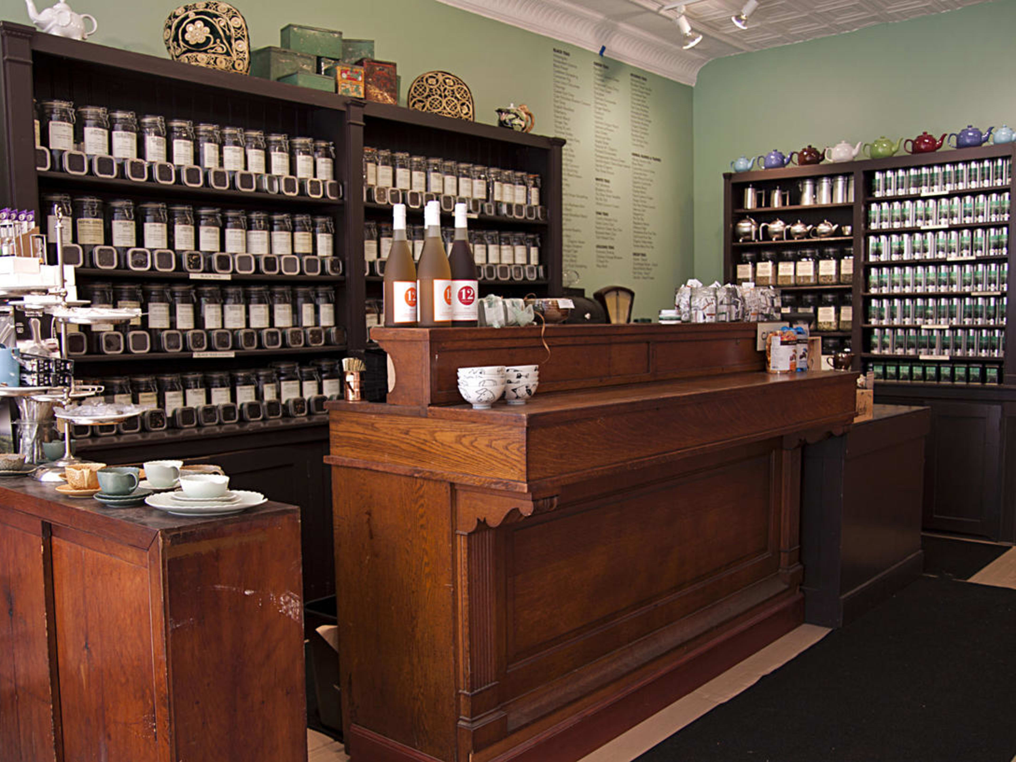 Verdigris Tea & Chocolate interiors with wooden shelves filled with products on display