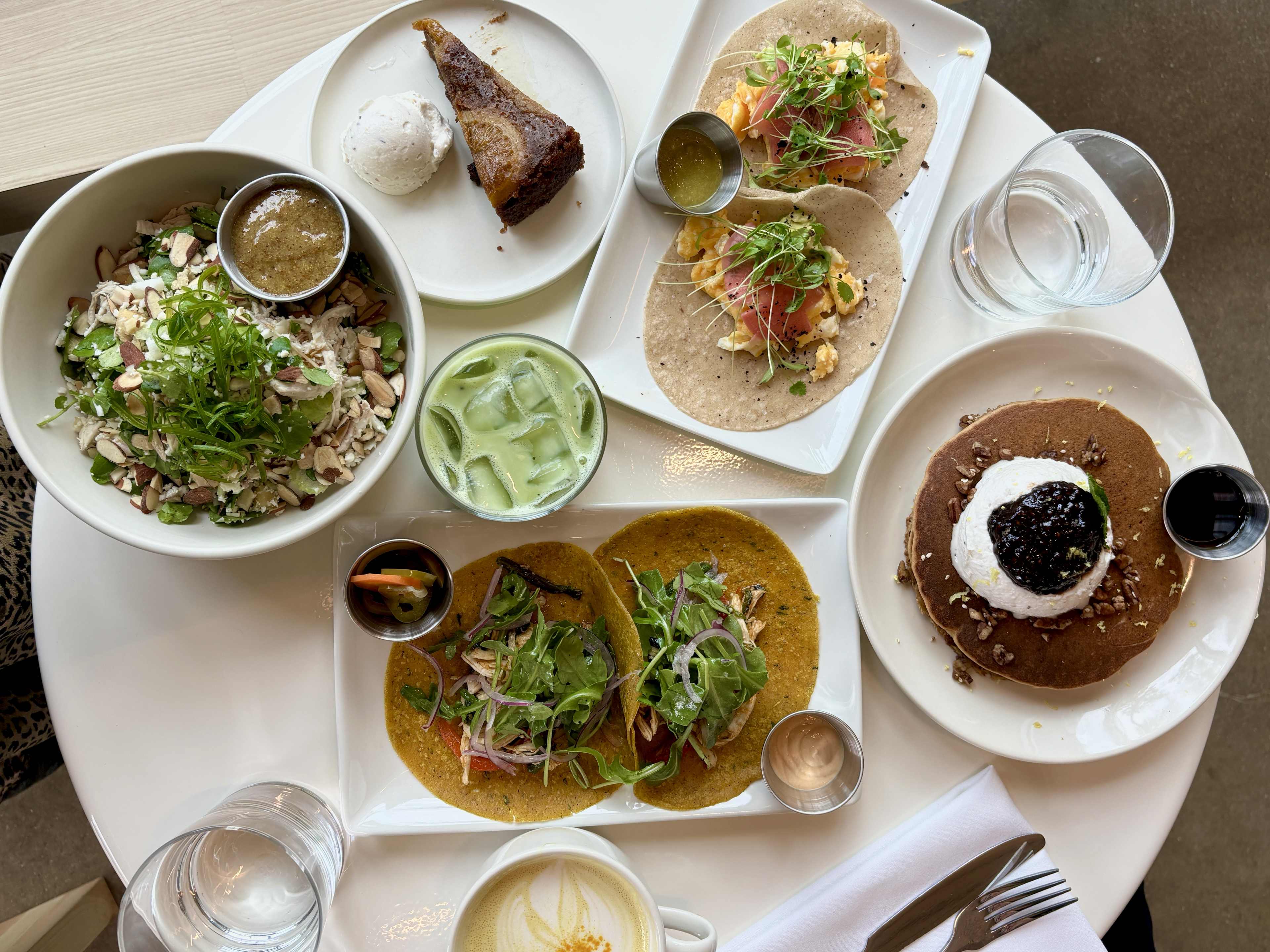 round table full of colorful plates of food and drinks at Vibrant