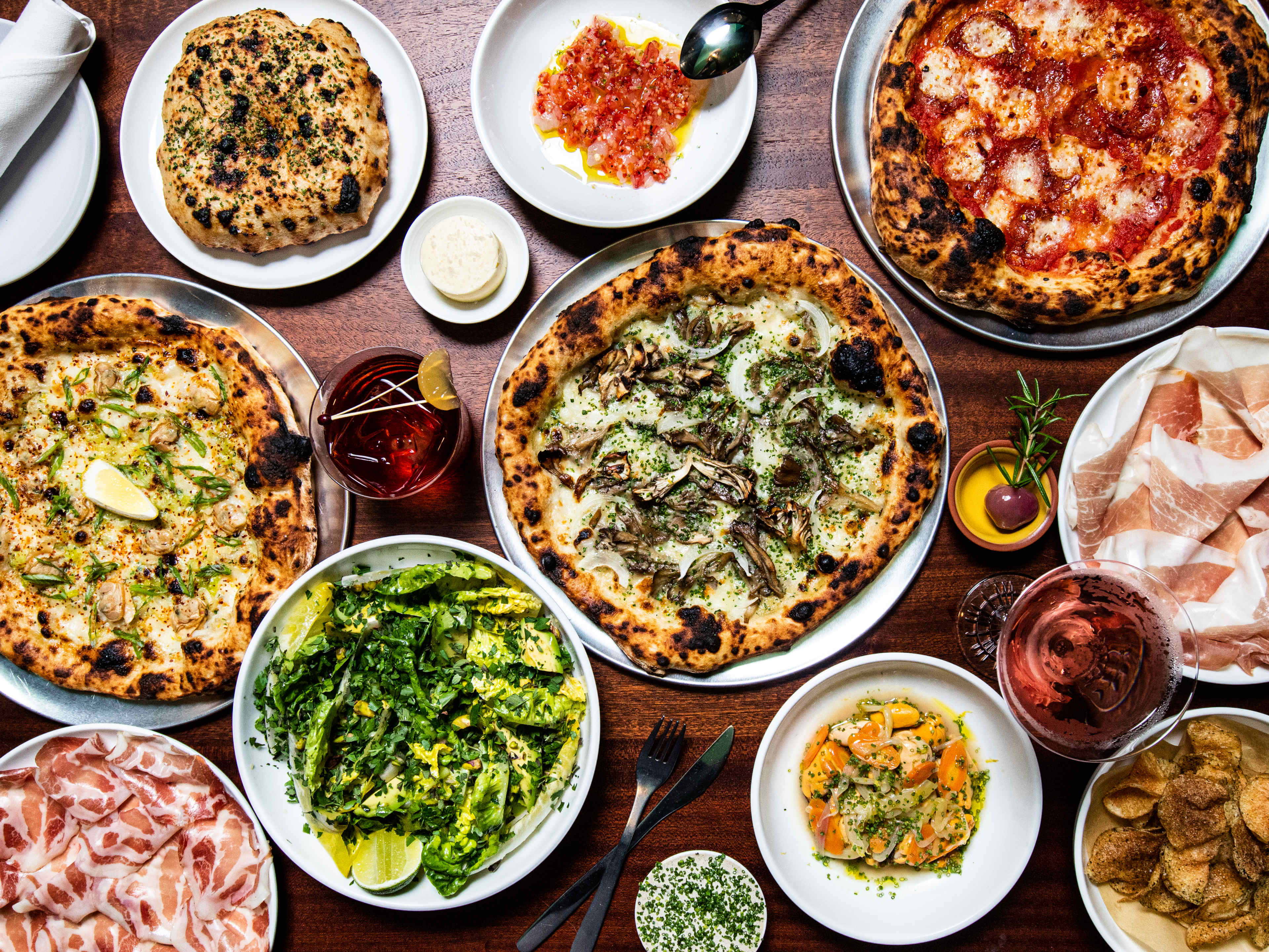 A spread of food, including pizza and salad.