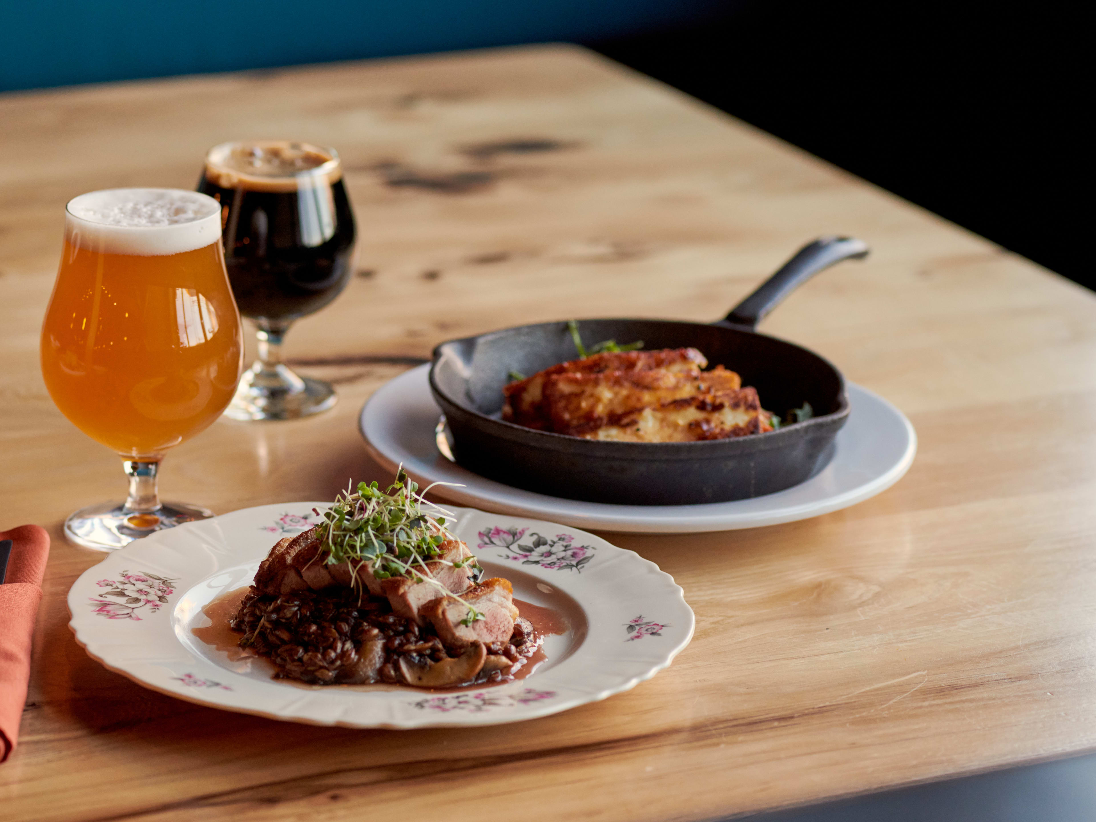 Spread of food in cast-iron skillet and draught beer at Wolf's Ridge Brewing