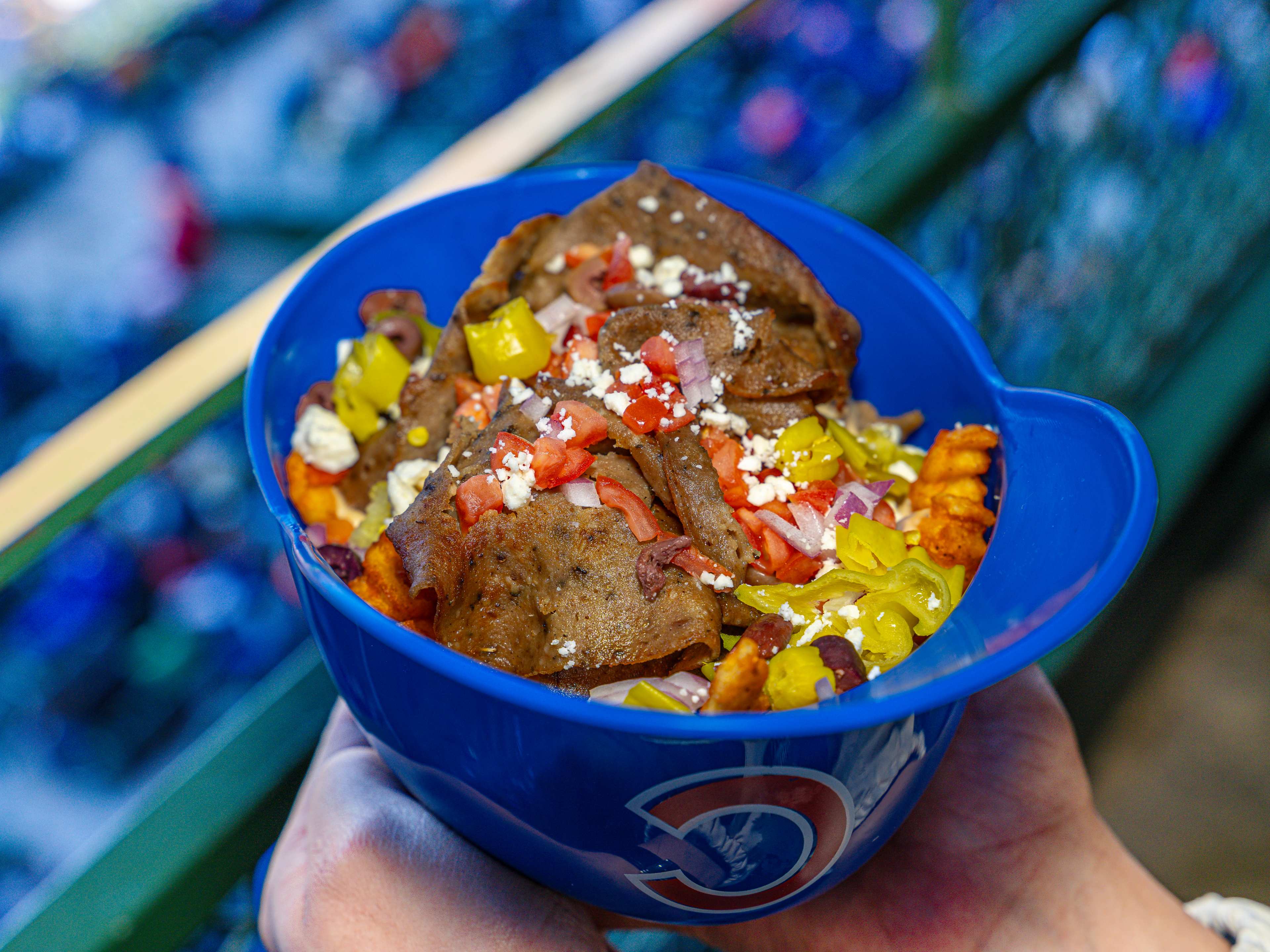 A Cubs baseball helmet full of Greek gyro fries.