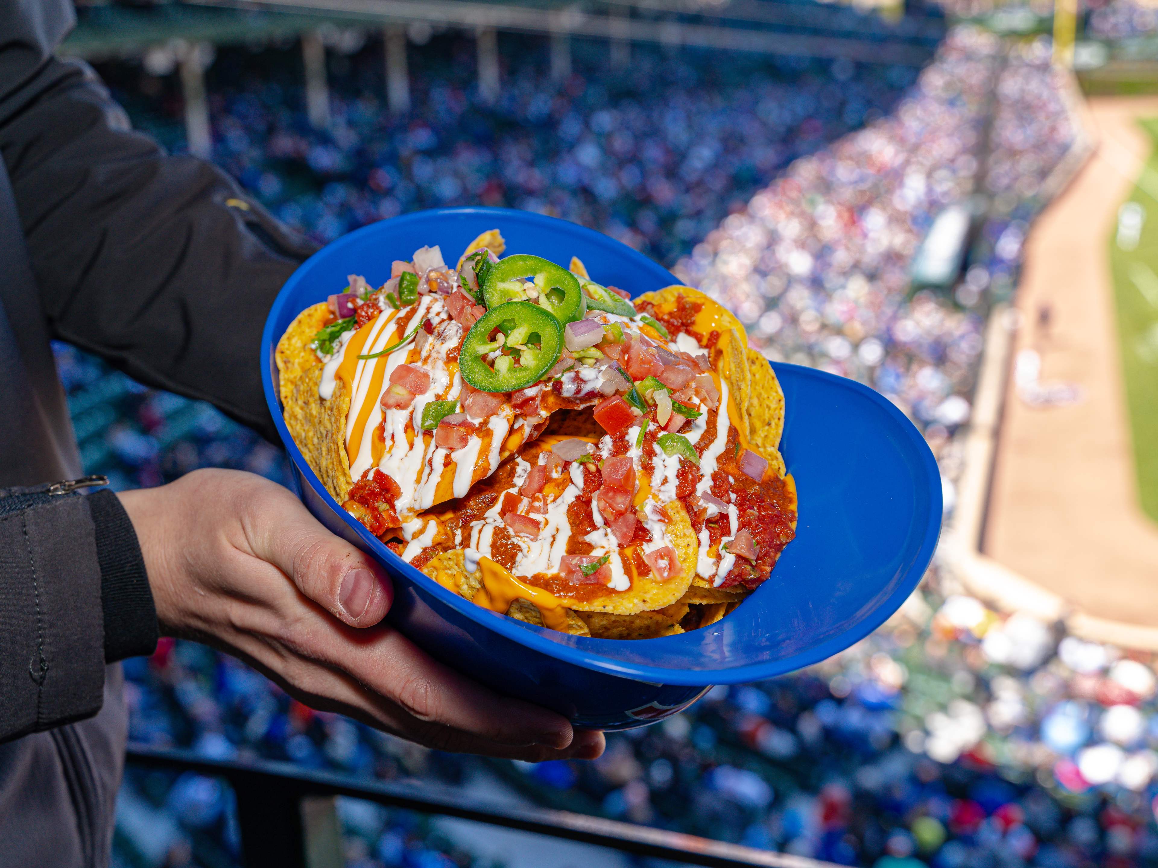 A Cubs baseball helmet full of loaded nachos.