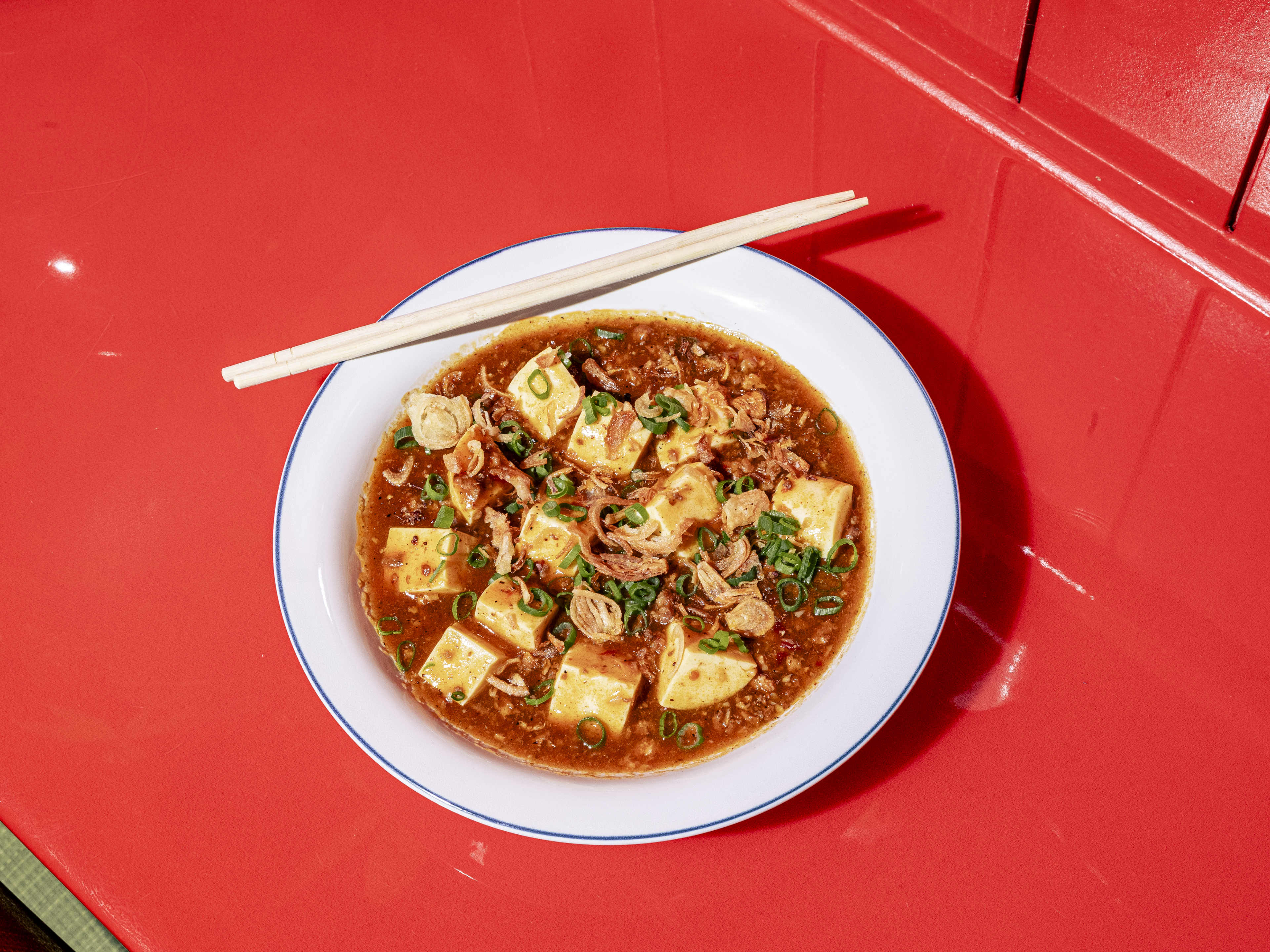 Mapo tofu with chopsticks in white ceramic bowl at Yaowarat