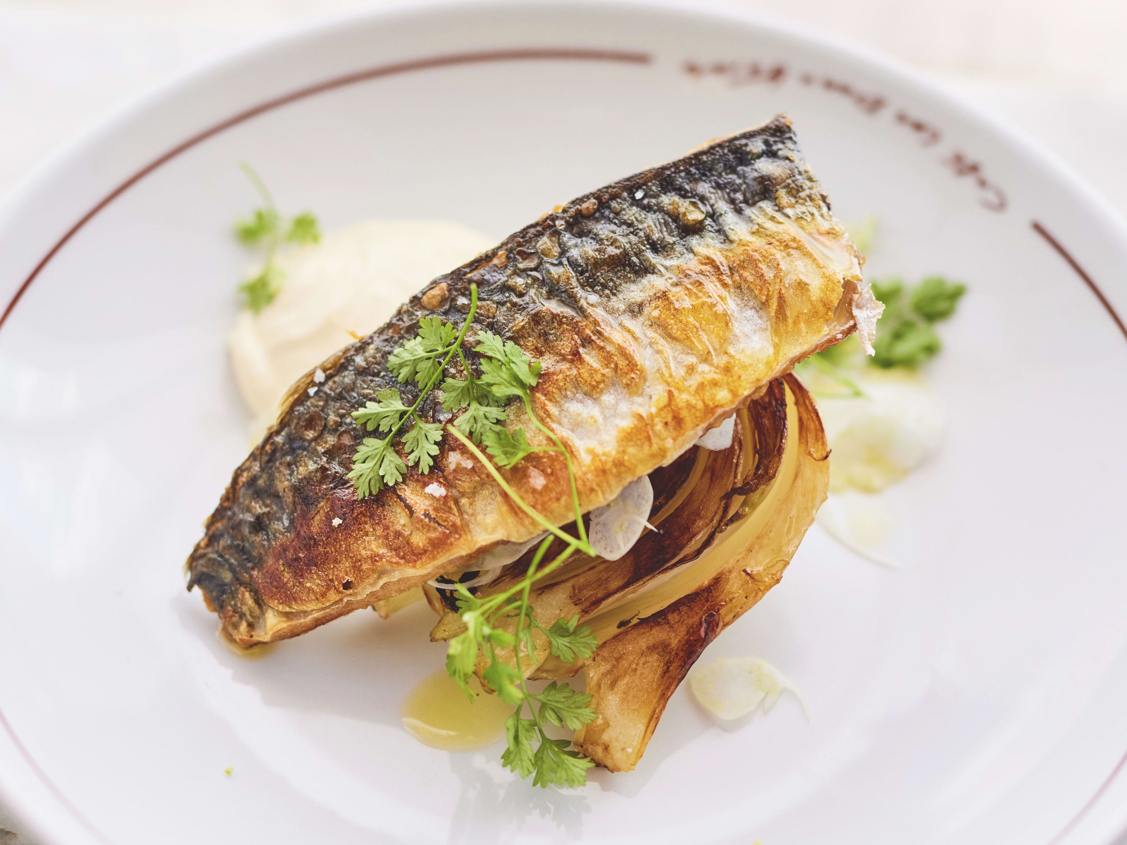 Grilled seafood dish on white tableware at Cafe les Deux Gares