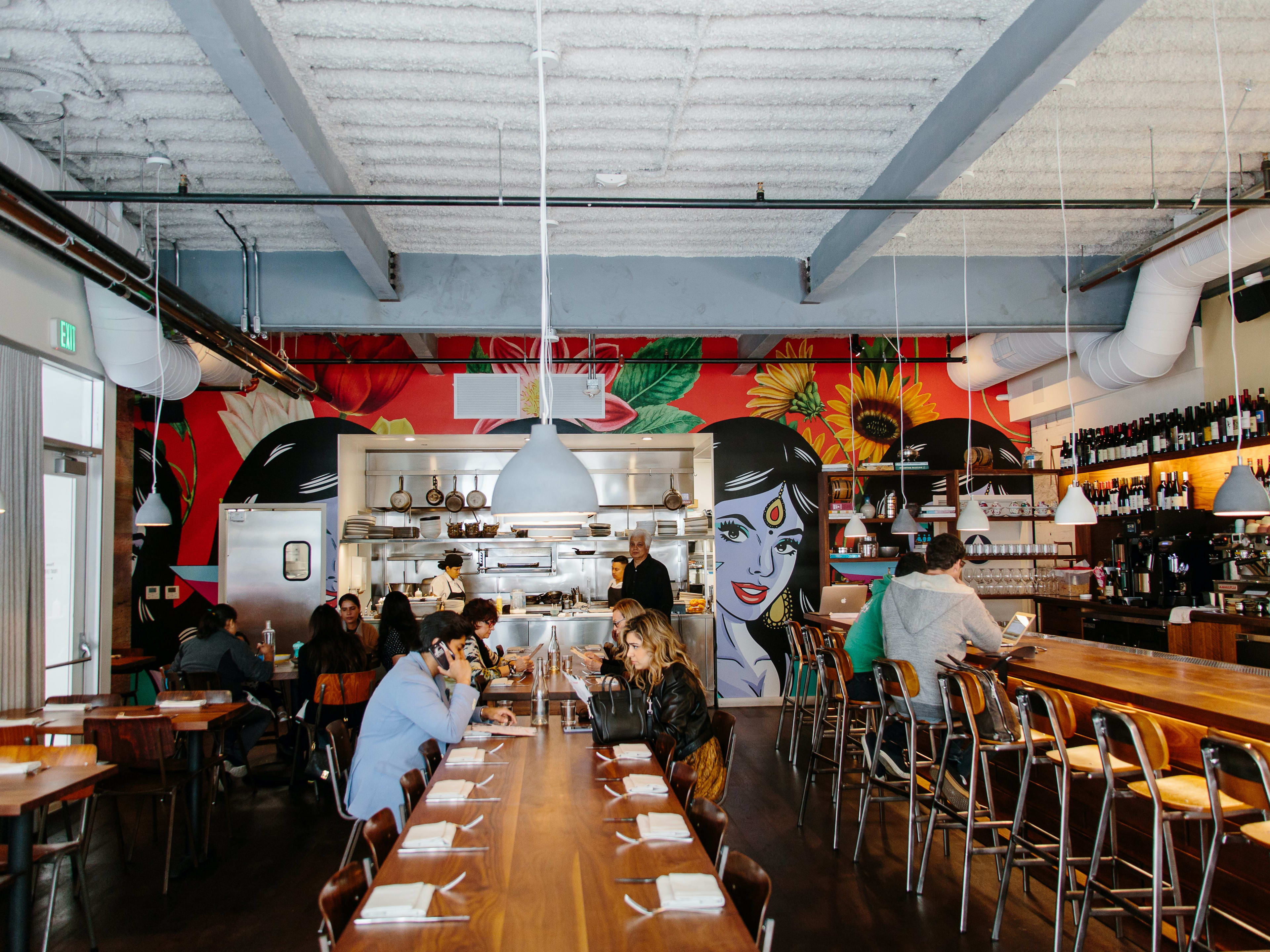 The dining room and mural of a woman at Besharam