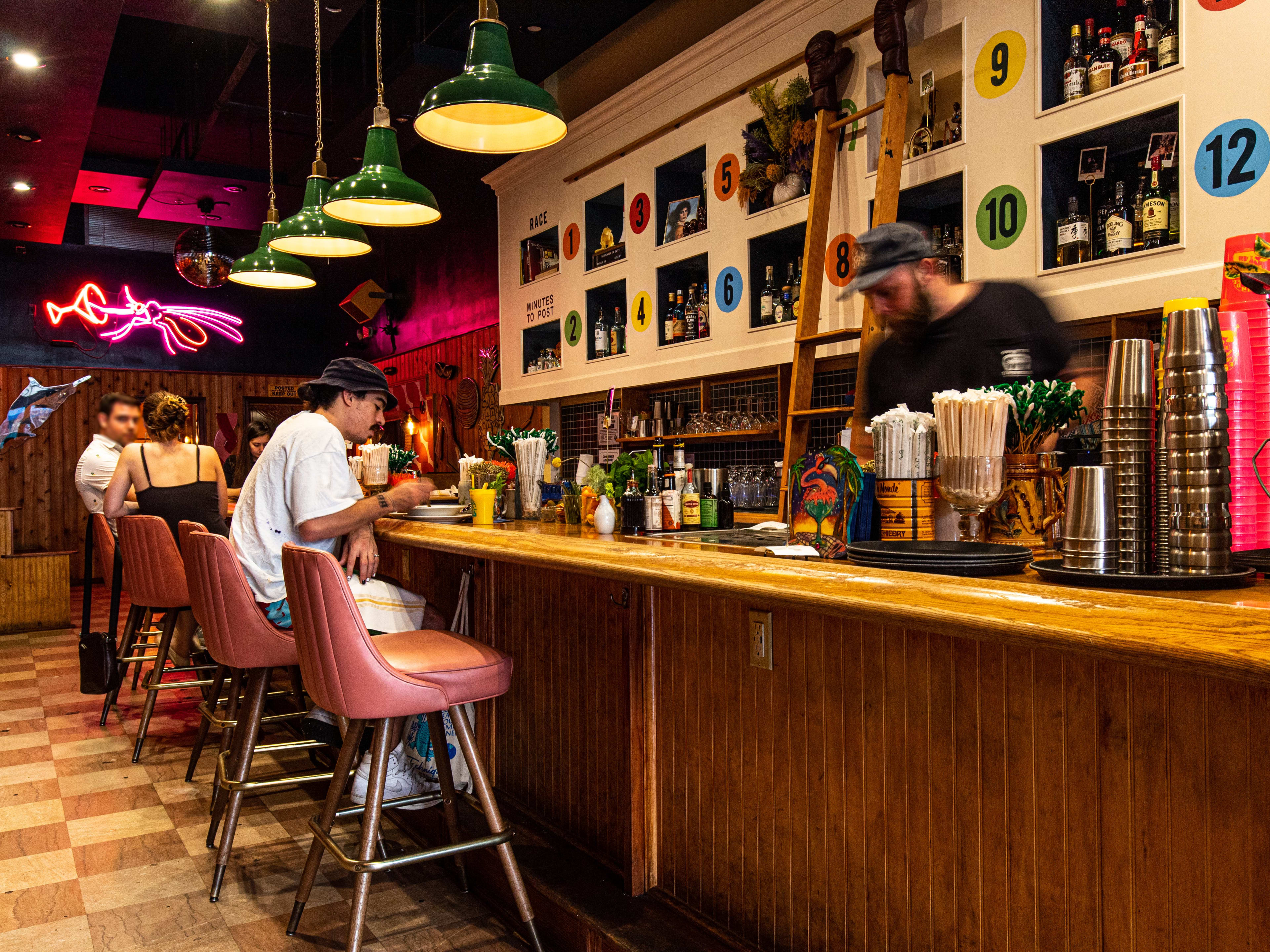 Interior with bar seating and neon sign