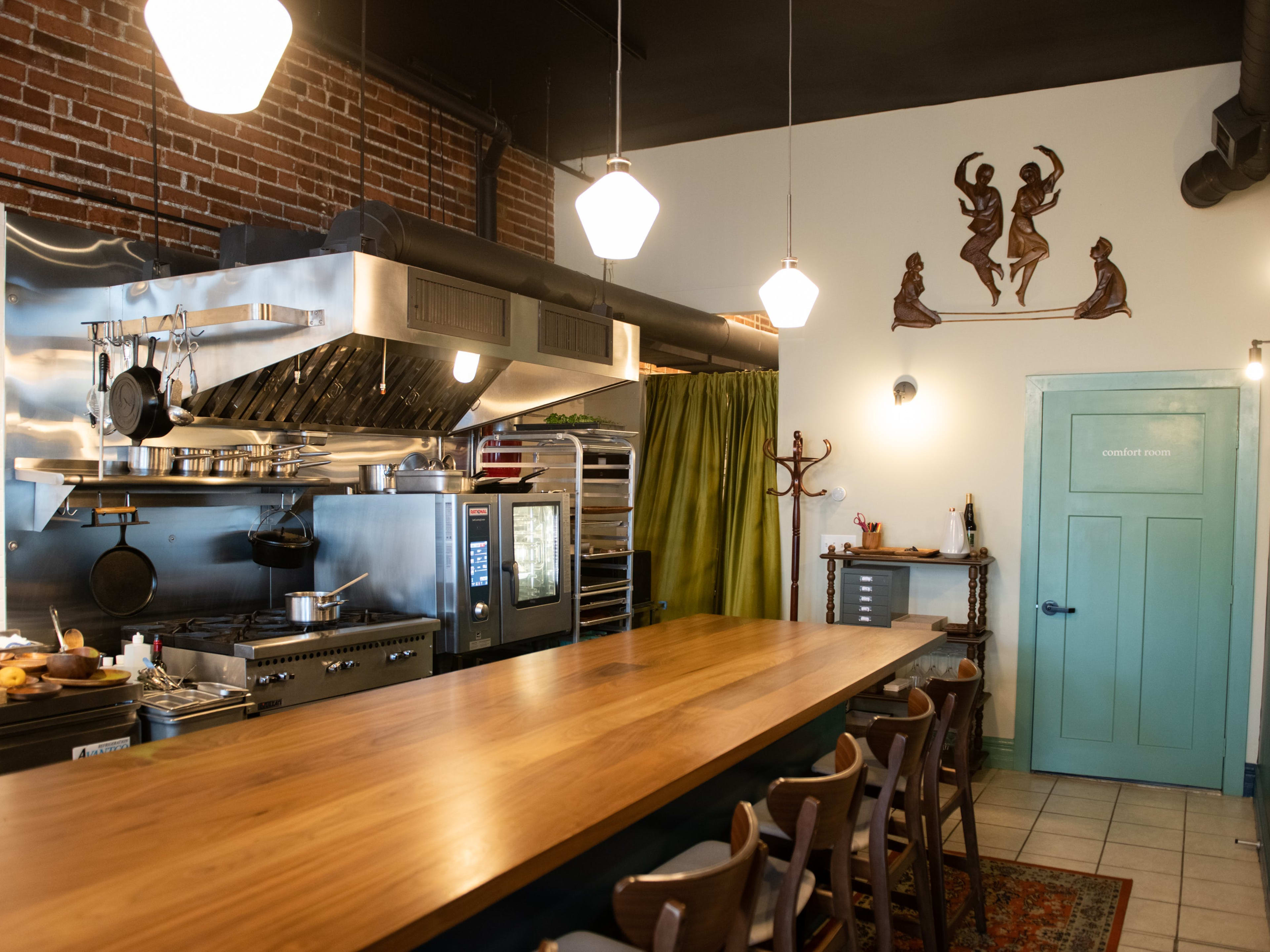 Dining counter with wooden chairs and open kitchen