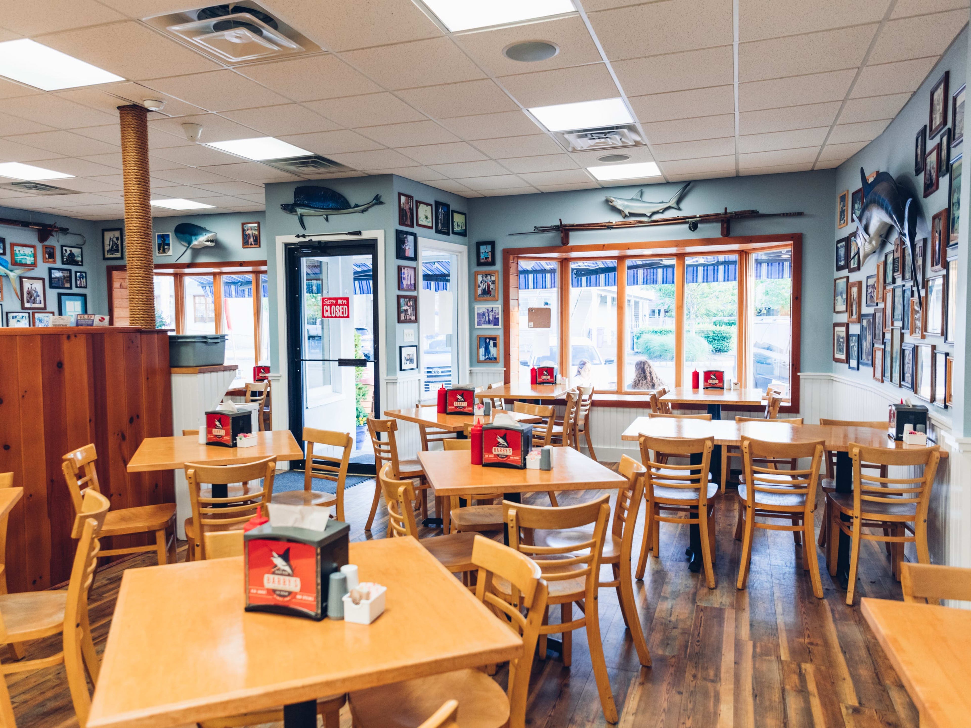 Barry's do me a flavor interiors with wooden tables and fish hung on the walls