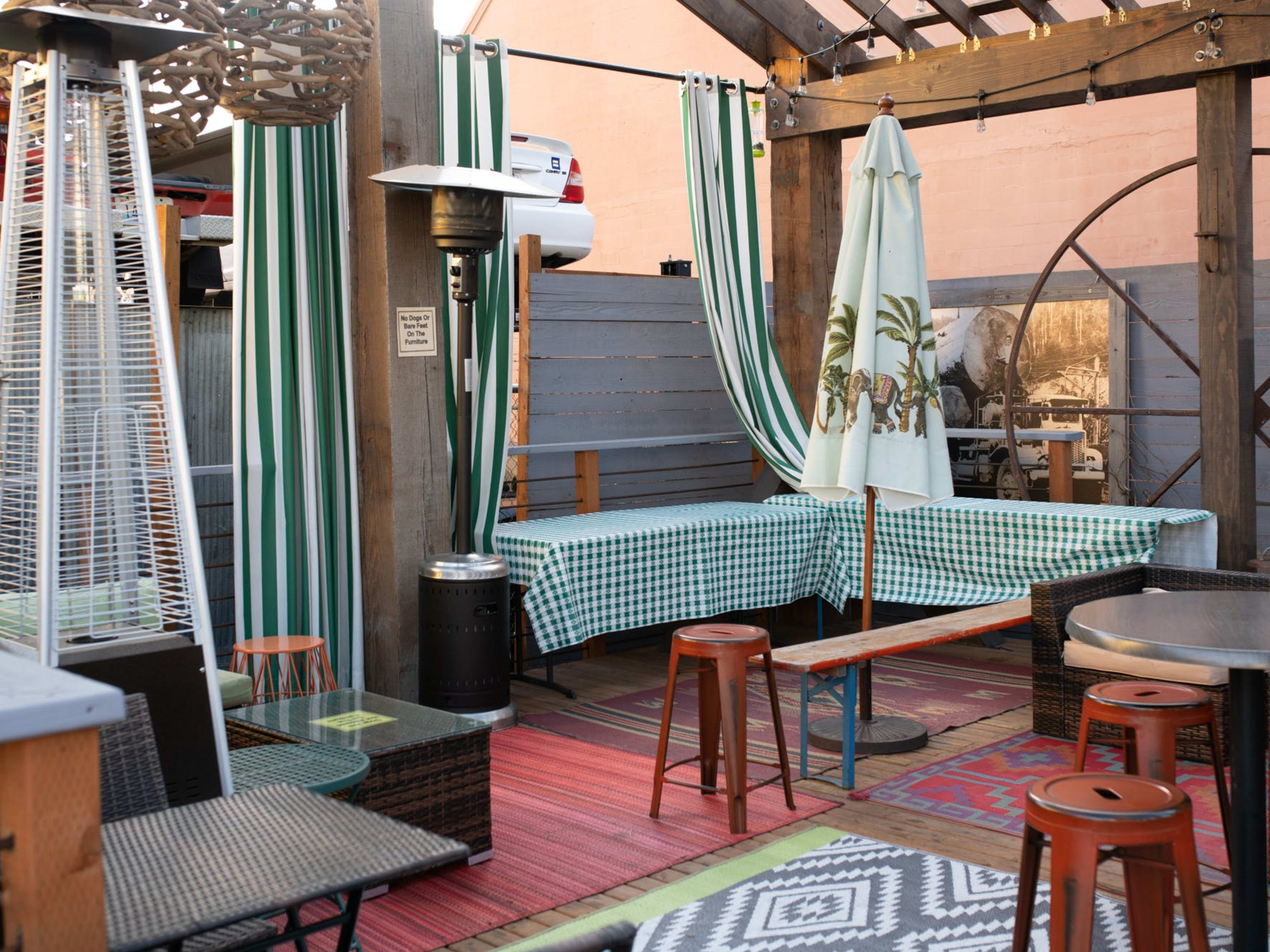 patio deck with barstools, outdoor heaters, and outdoor rugs