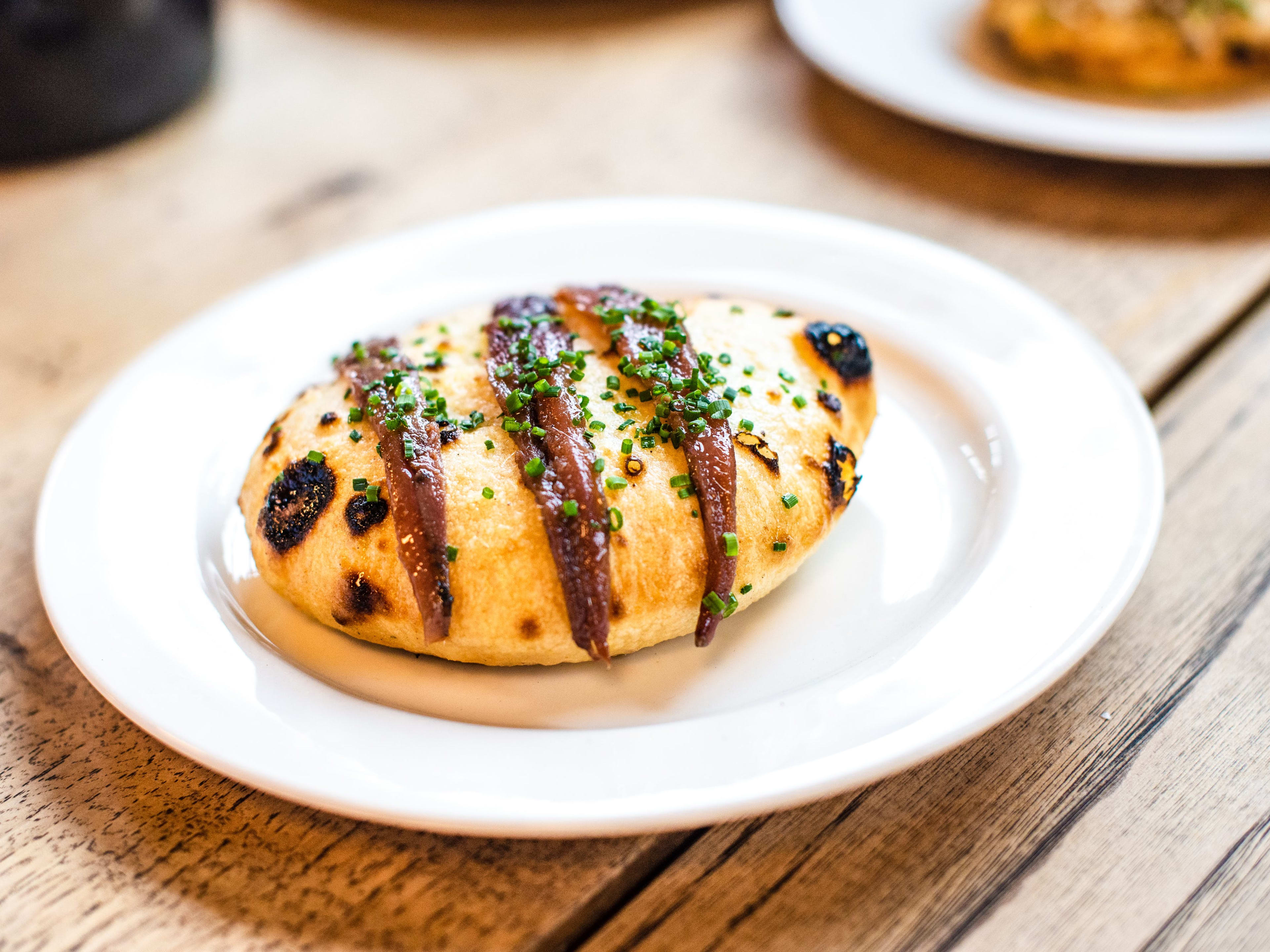 Grilled bread with anchovy from Brat.