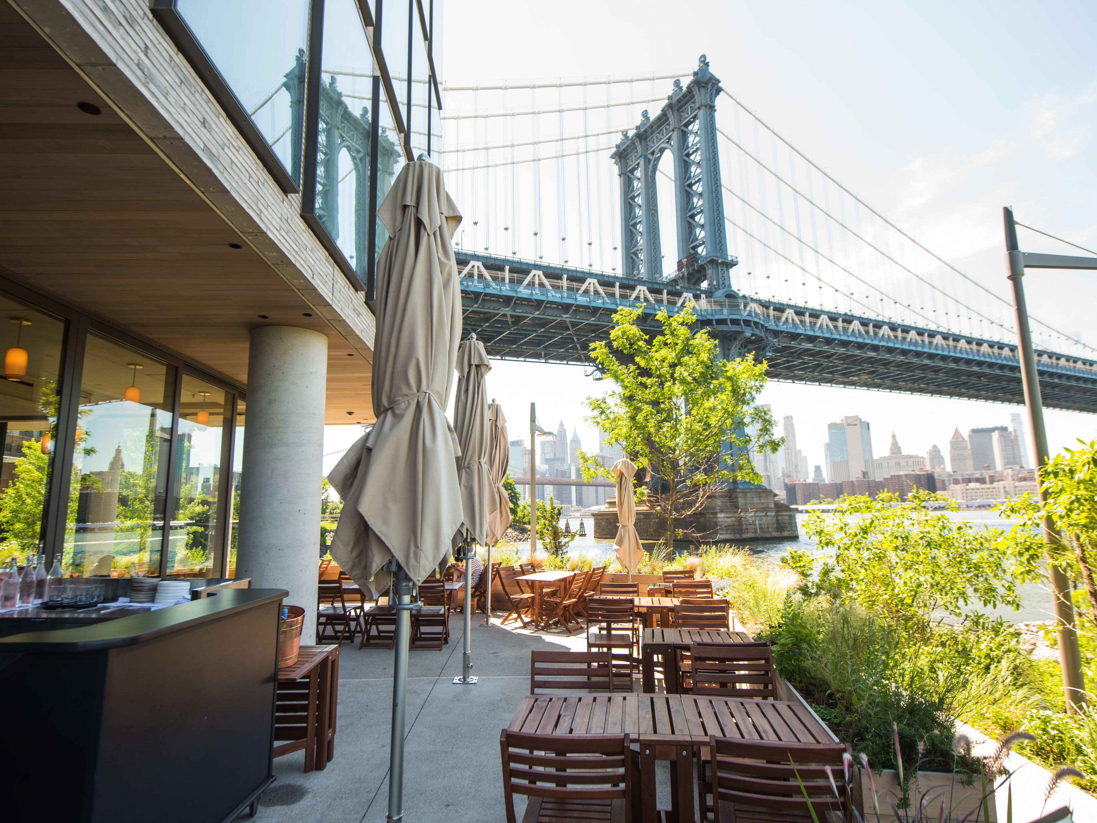 The outdoor seating area at Celestine and a view of the Brooklyn Bridge.